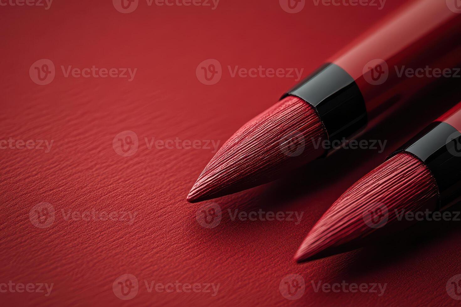Close up of red lip pencils on textured surface photo
