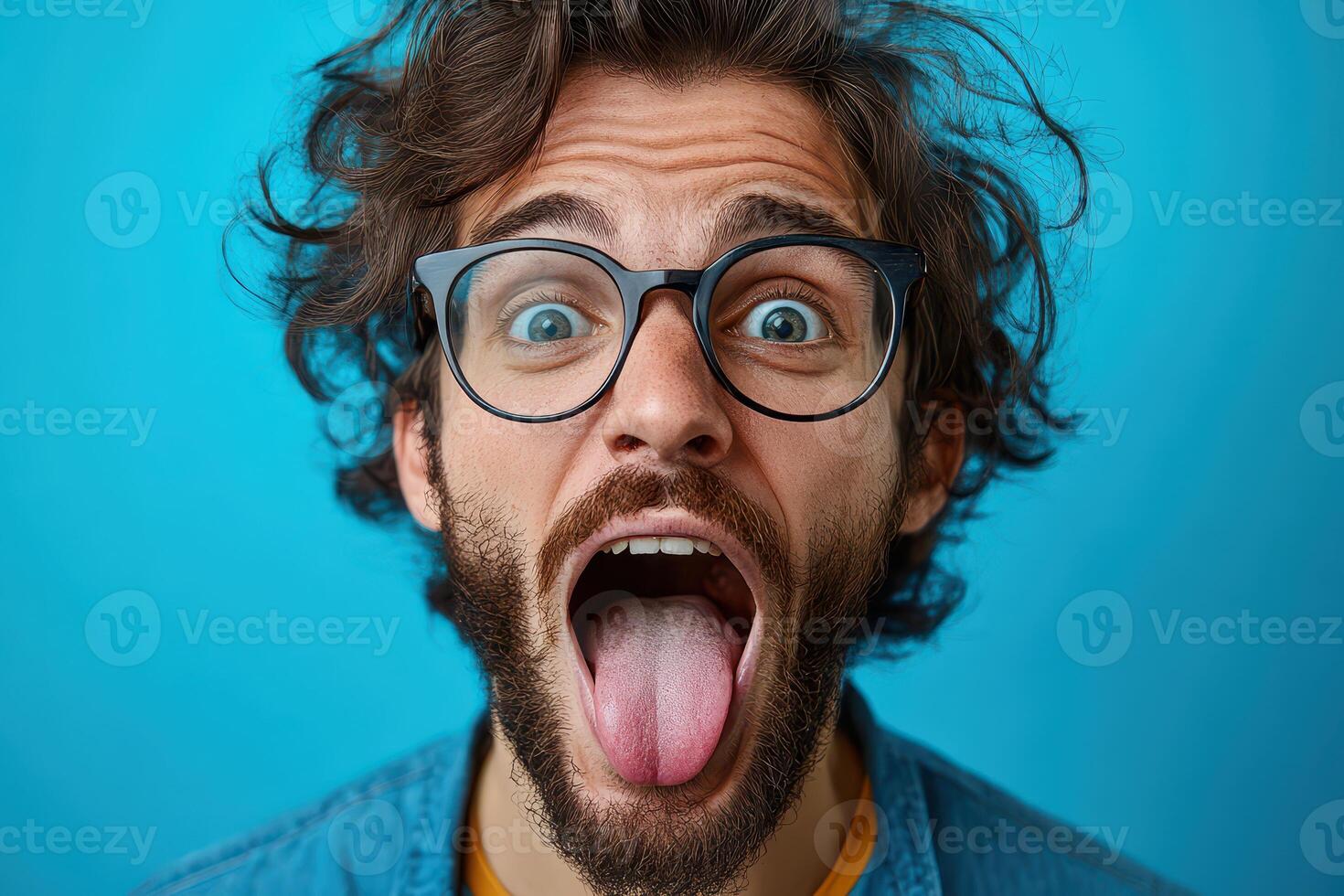 Man making a funny face with blue background photo