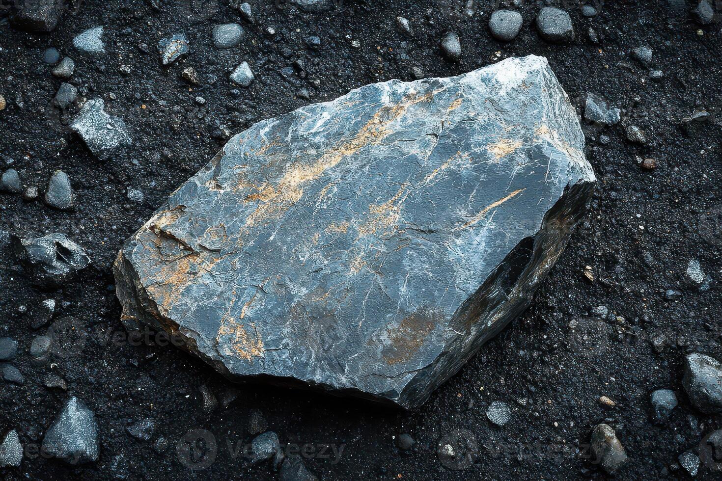 Dark rock on black gravel in sunlight photo