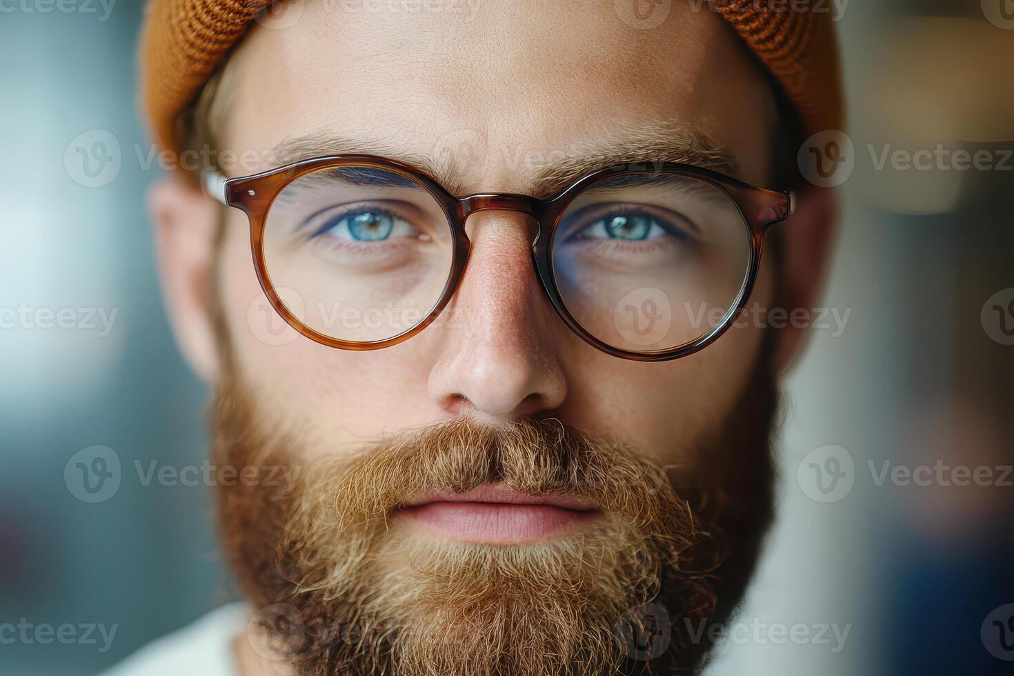 Young man with glasses and beard in cozy setting photo