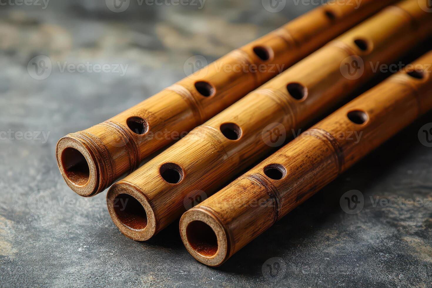 Bamboo flutes arranged on a textured surface photo