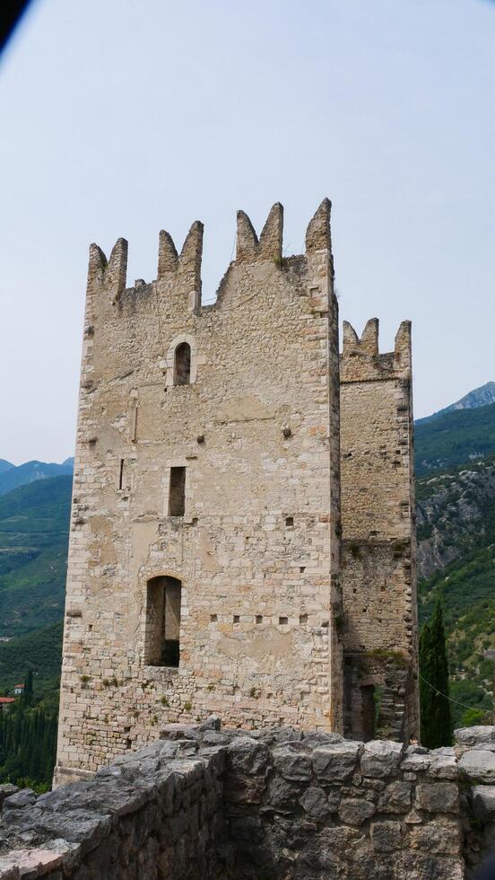 Historic tower stands majestically against serene mountains in early morning light photo