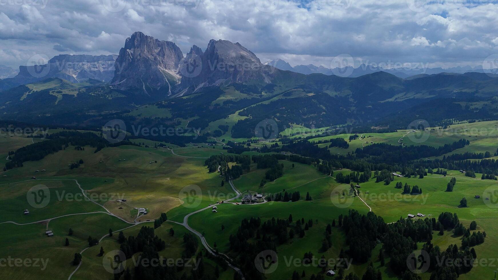 Breathtaking view of emerald valleys and majestic mountains in the Dolomites during a vibrant afternoon photo