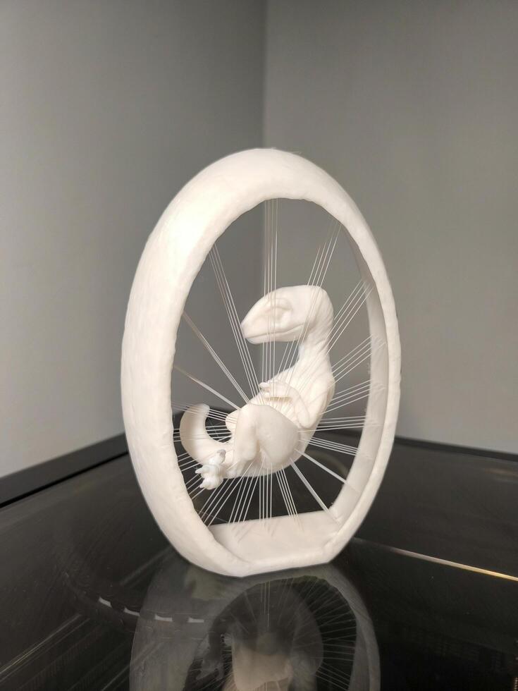 A stunning sculptural representation of a lizard suspended in dynamic motion, captured amidst an elegant circular frame in a serene gallery setting photo