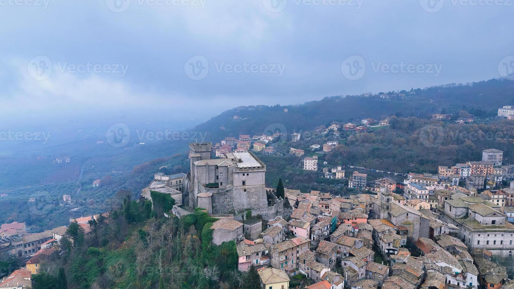 Exploring the ancient fortifications of an Italian village nestled in the misty hills at dawn photo