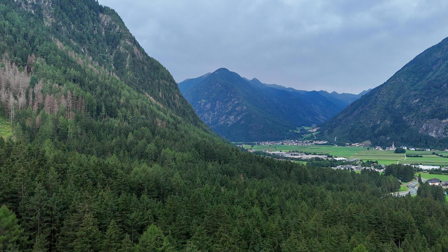 Majestic mountain landscape with lush forests and valleys at twilight in a serene wilderness area photo