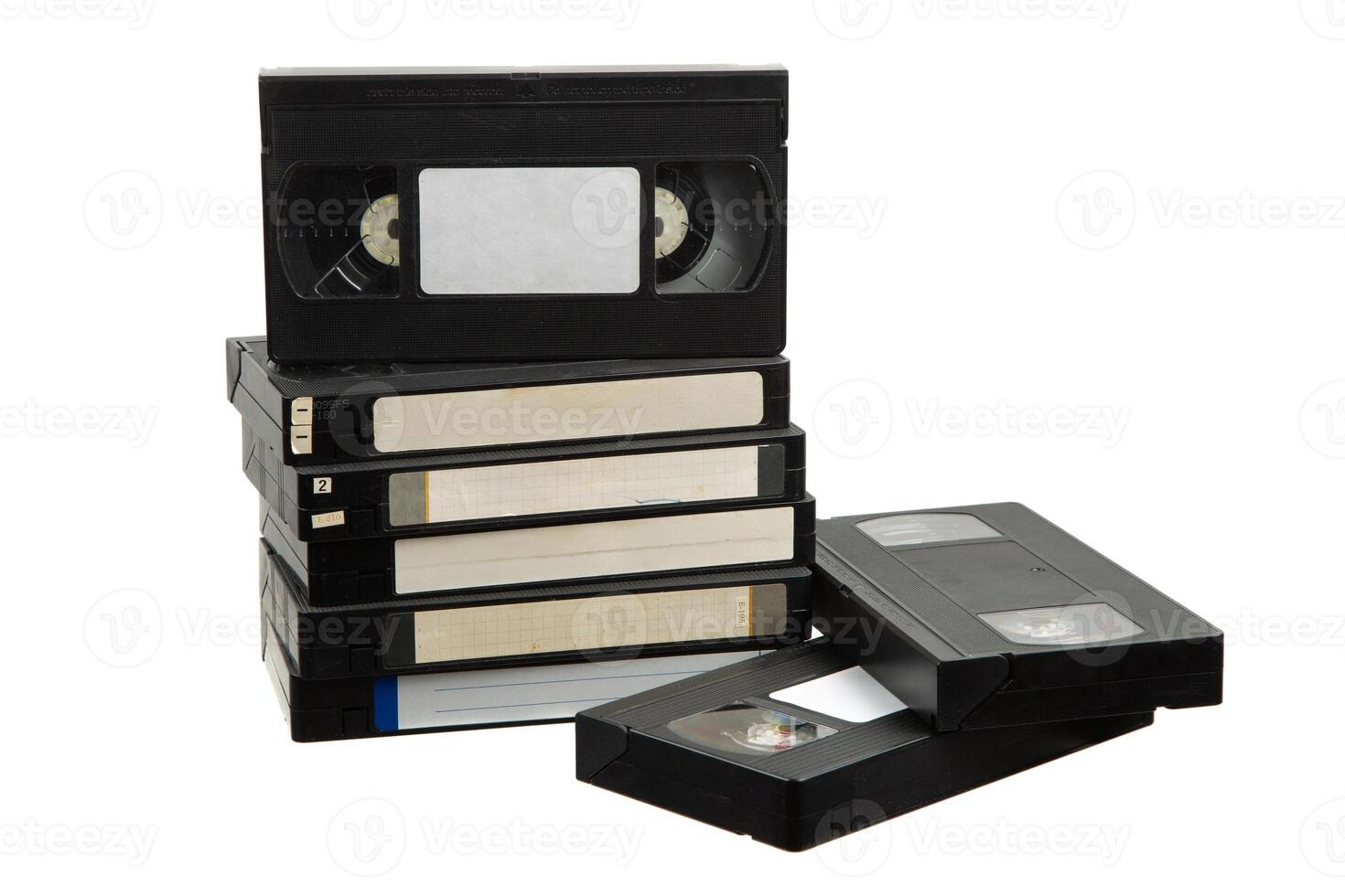 Stack of retro VHS tapes with blank labels on white photo
