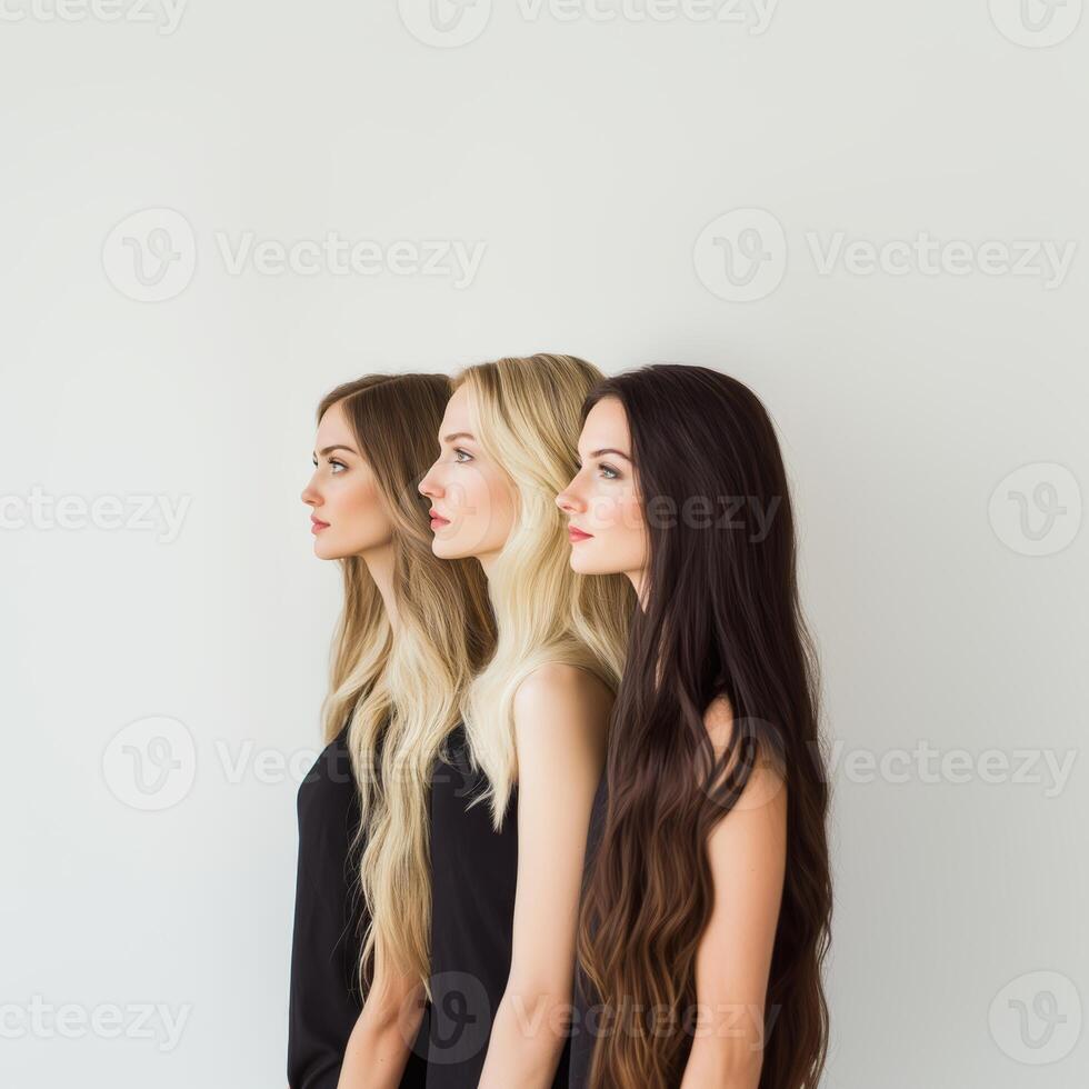 Professional female models displaying diverse hair colors, standing in profile, wearing black tank tops during studio photoshoot with minimalist white backdrop photo