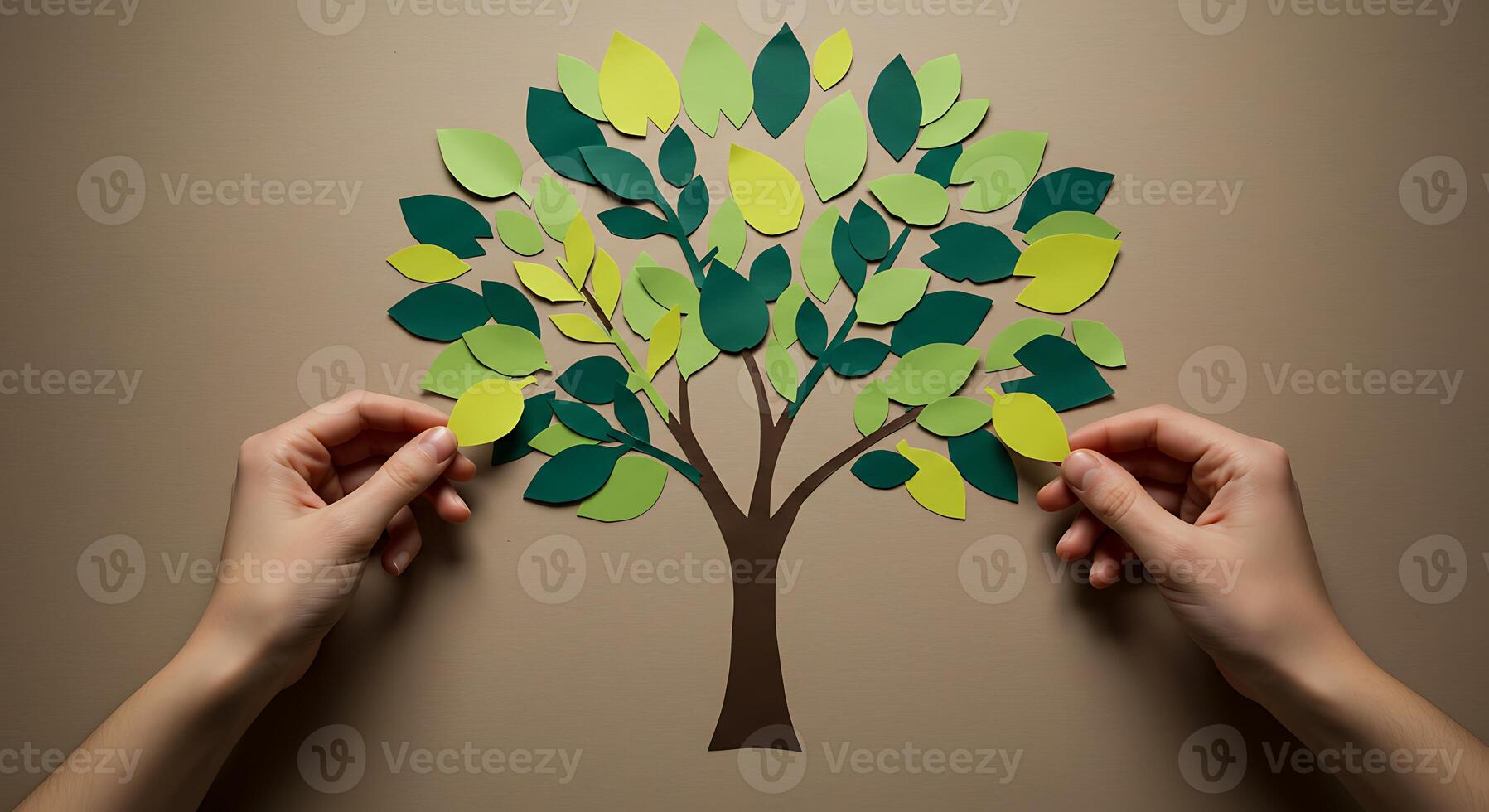 Paper cut tree concept with hands holding it photo