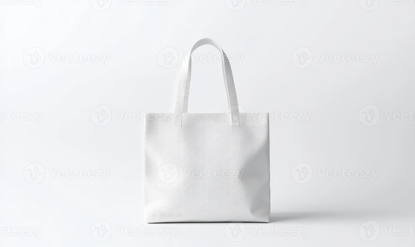 A white bag with a black handle sits on a white background photo