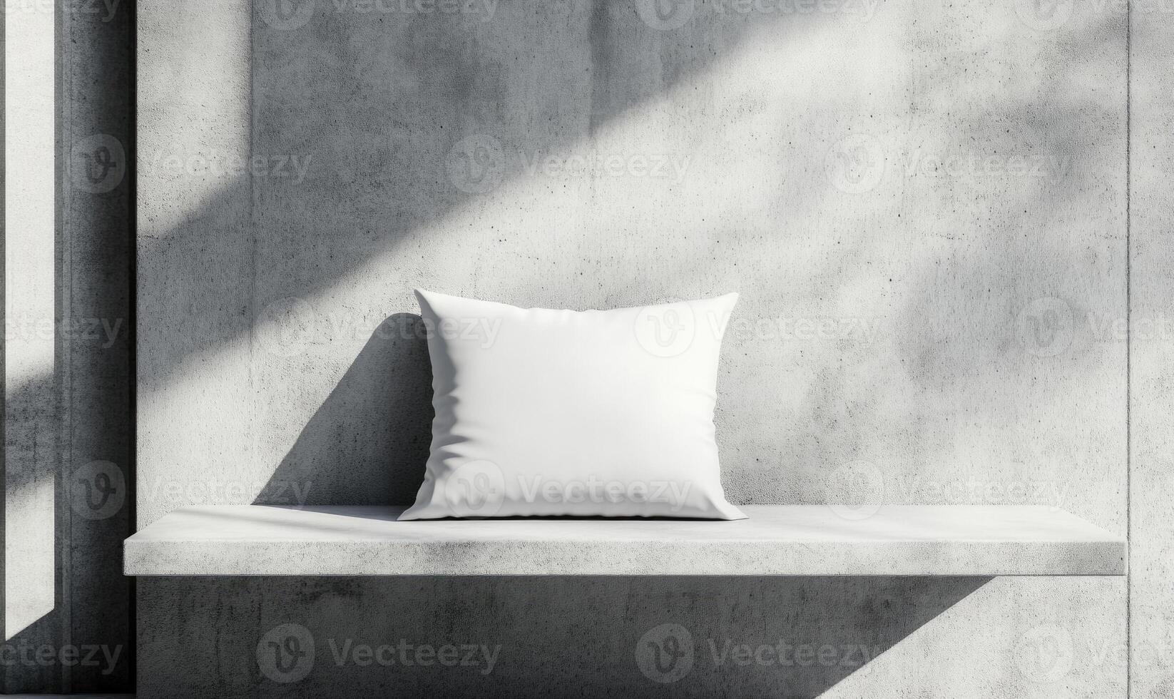 a white pillow on a concrete wall photo