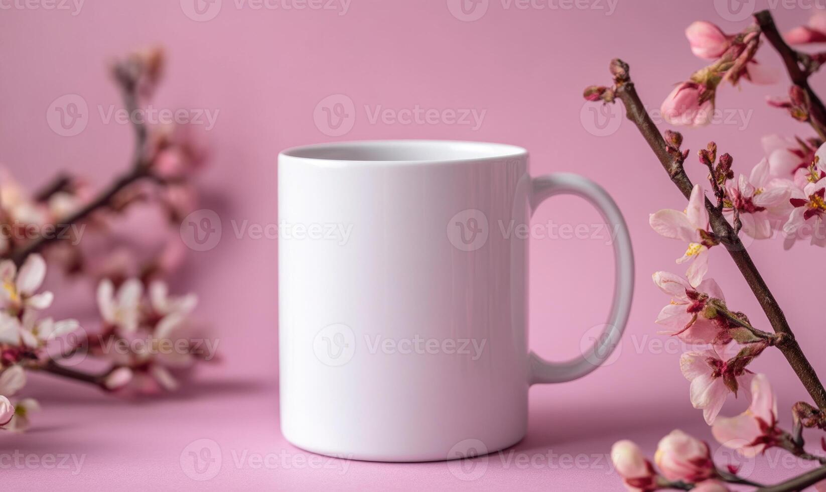 A white coffee cup sits on a pink background with pink flowers photo