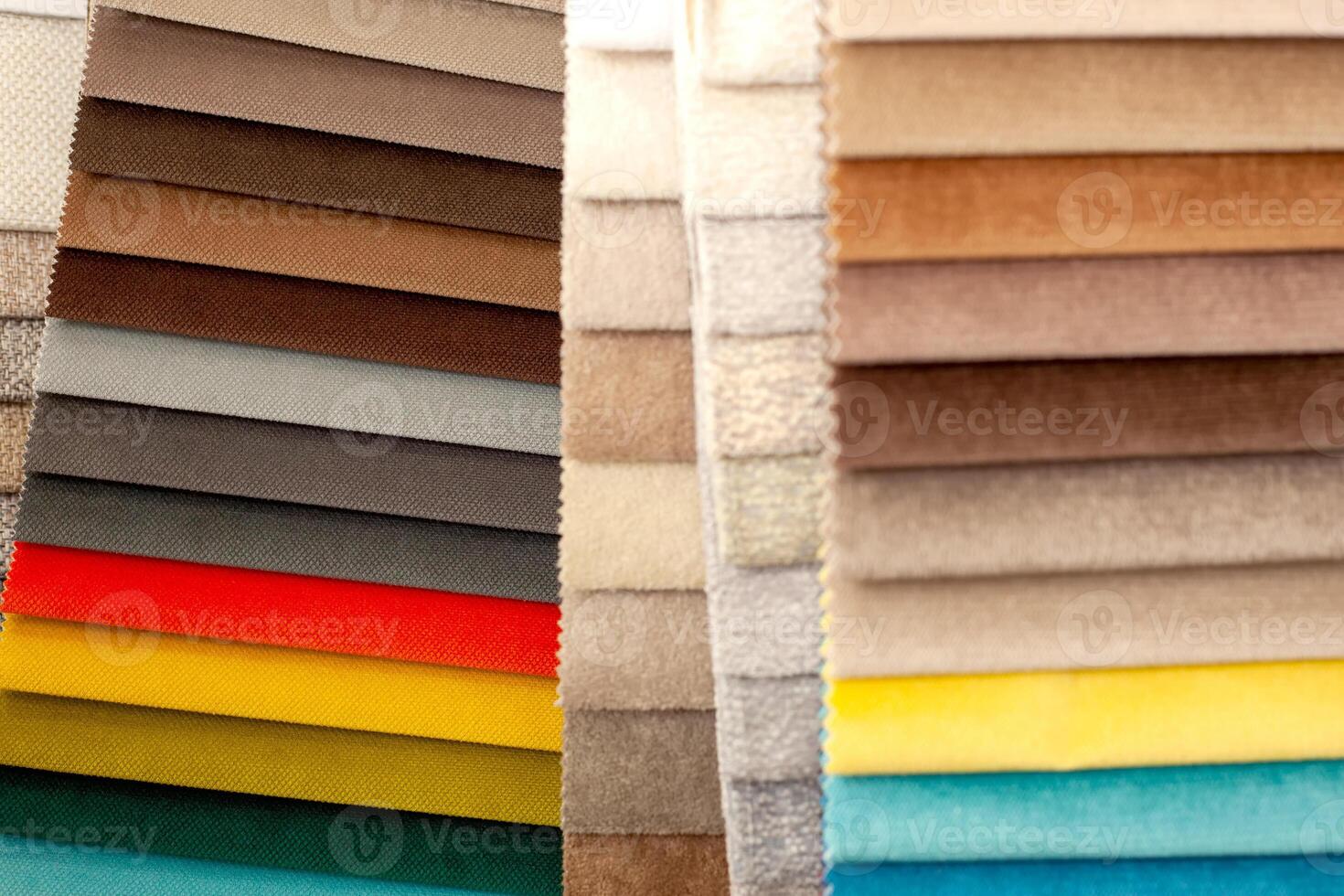 Catalog of textiles for the manufacture of upholstered furniture. Samples of multicolored fabrics. Choosing the color of the sofa. Background for the textile industry. photo