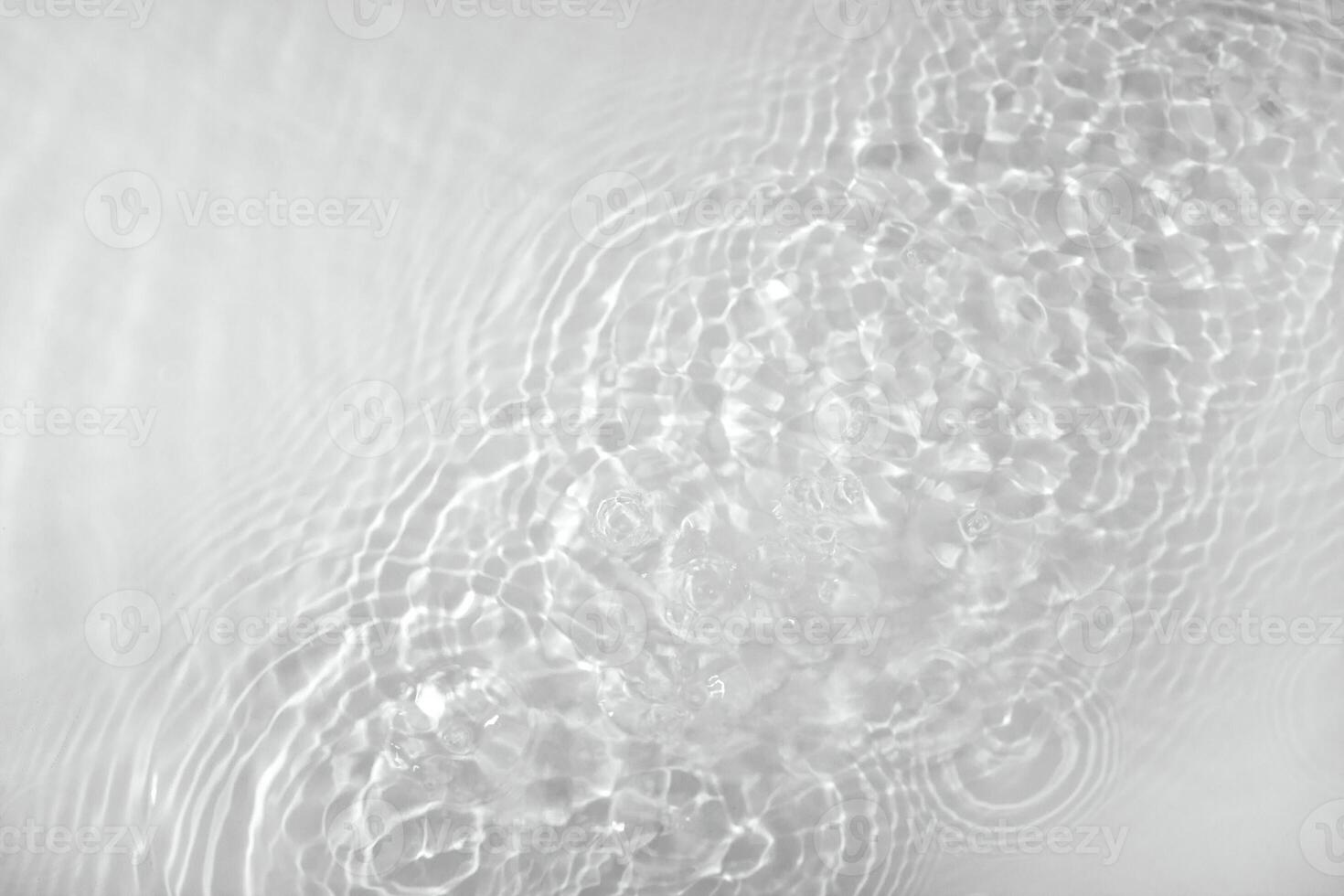 Background with clear water. Water background with small bubbles. transparent water surface with splashes and wave texture with ripples. Top view, a place to copy photo