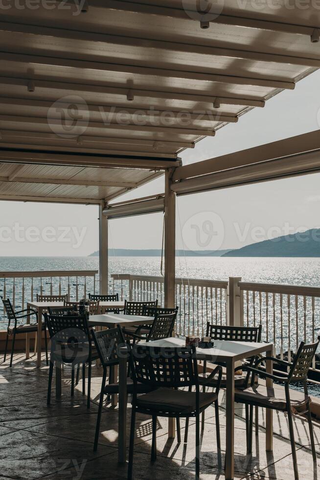 Empty cafe by the sea in Herceg Novi in a beautiful sunny day, Montenegro. Amazing view of Adriatic sea. photo