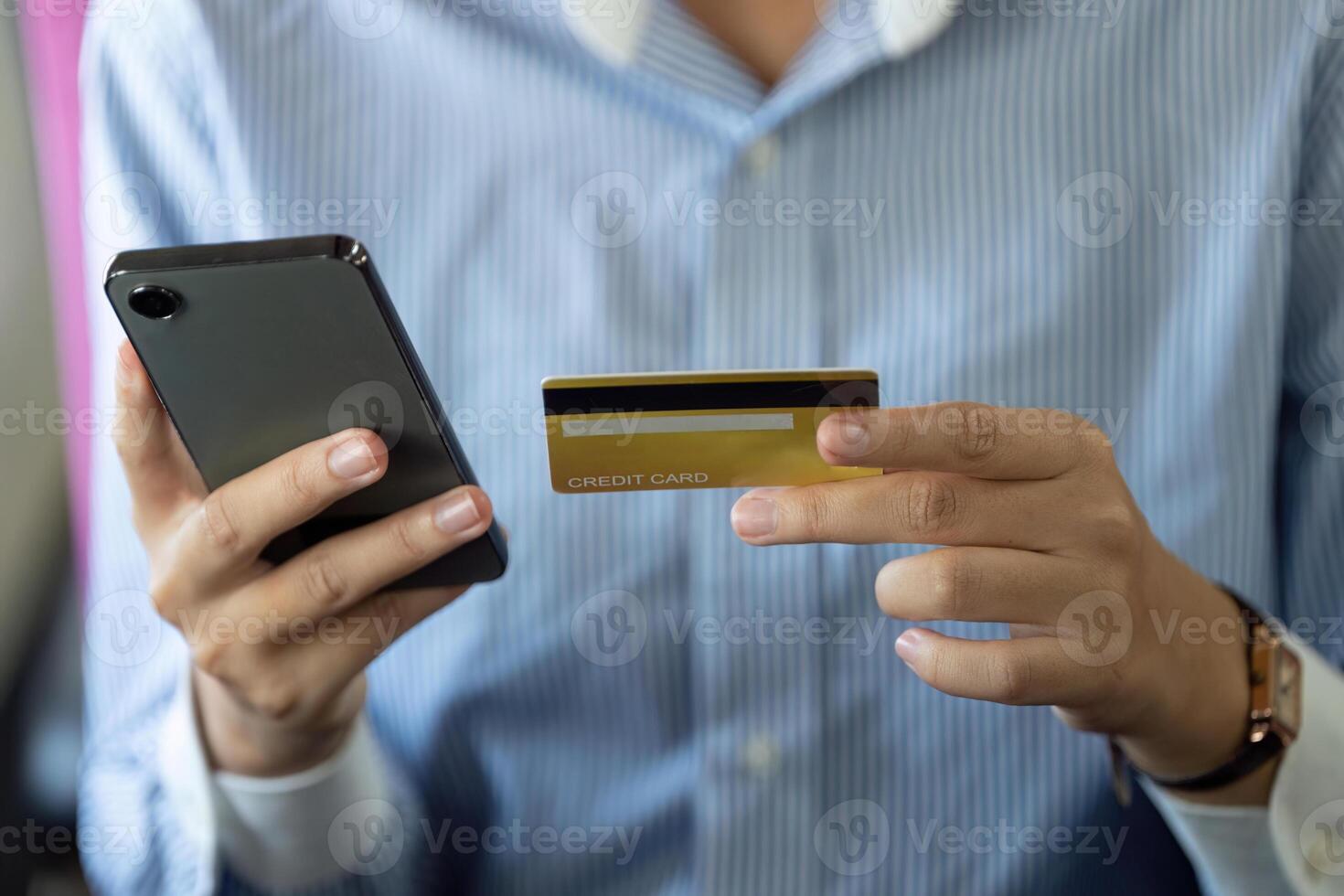 Business travel. Woman using smartphone and credit card to manage expenses photo
