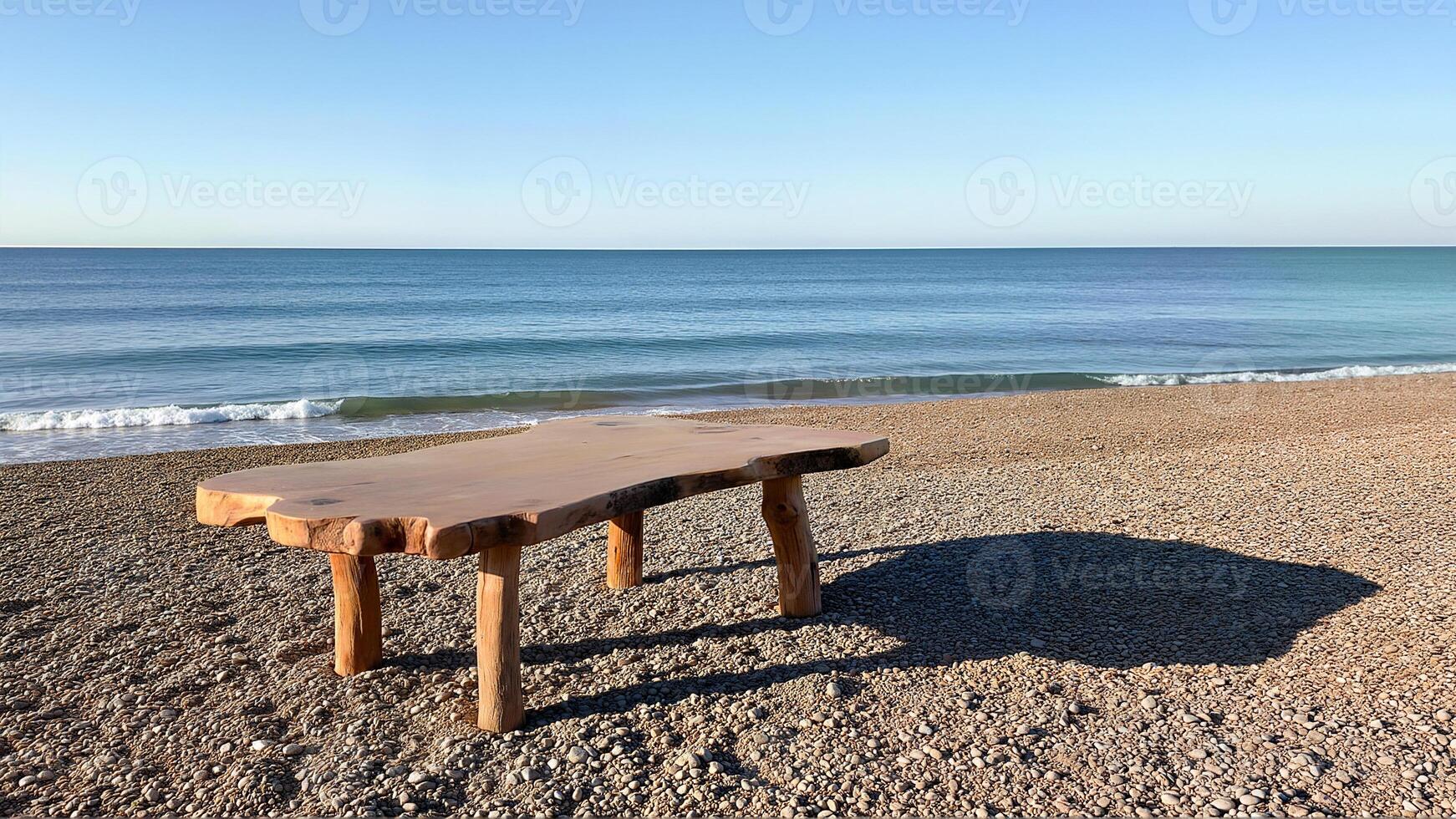 Rustic Wooden Table on Pebble Beach Shore and sea photo