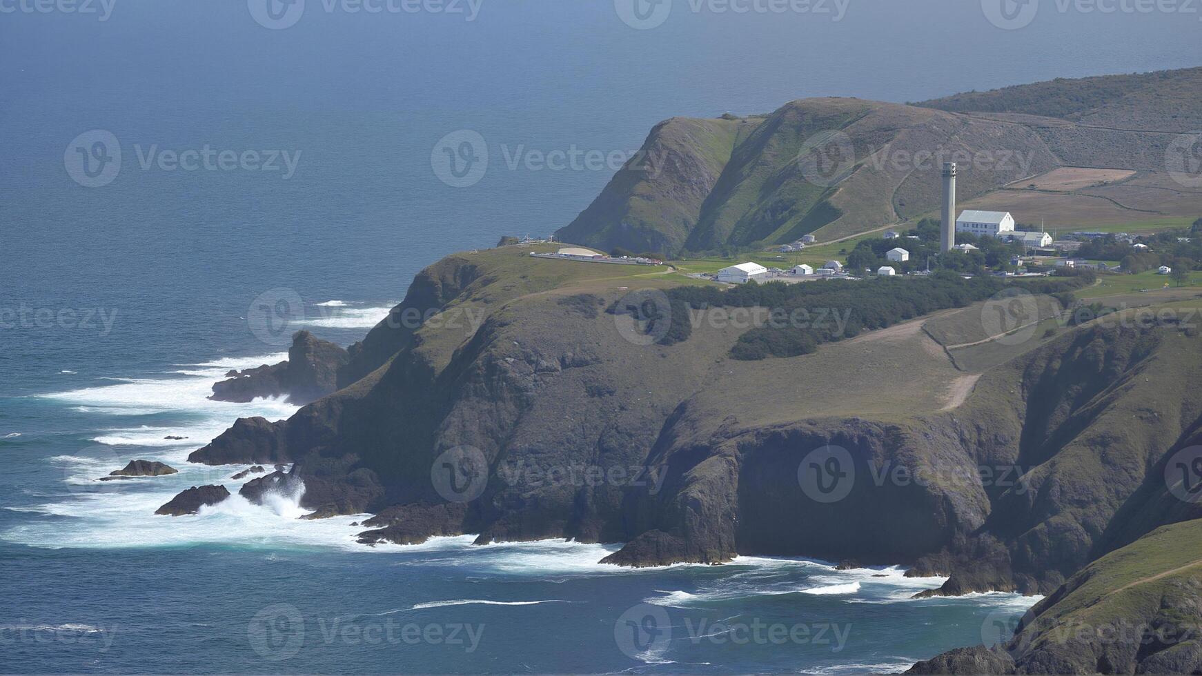 Aerial View of Coastal Cliffs and Lighthouse photo