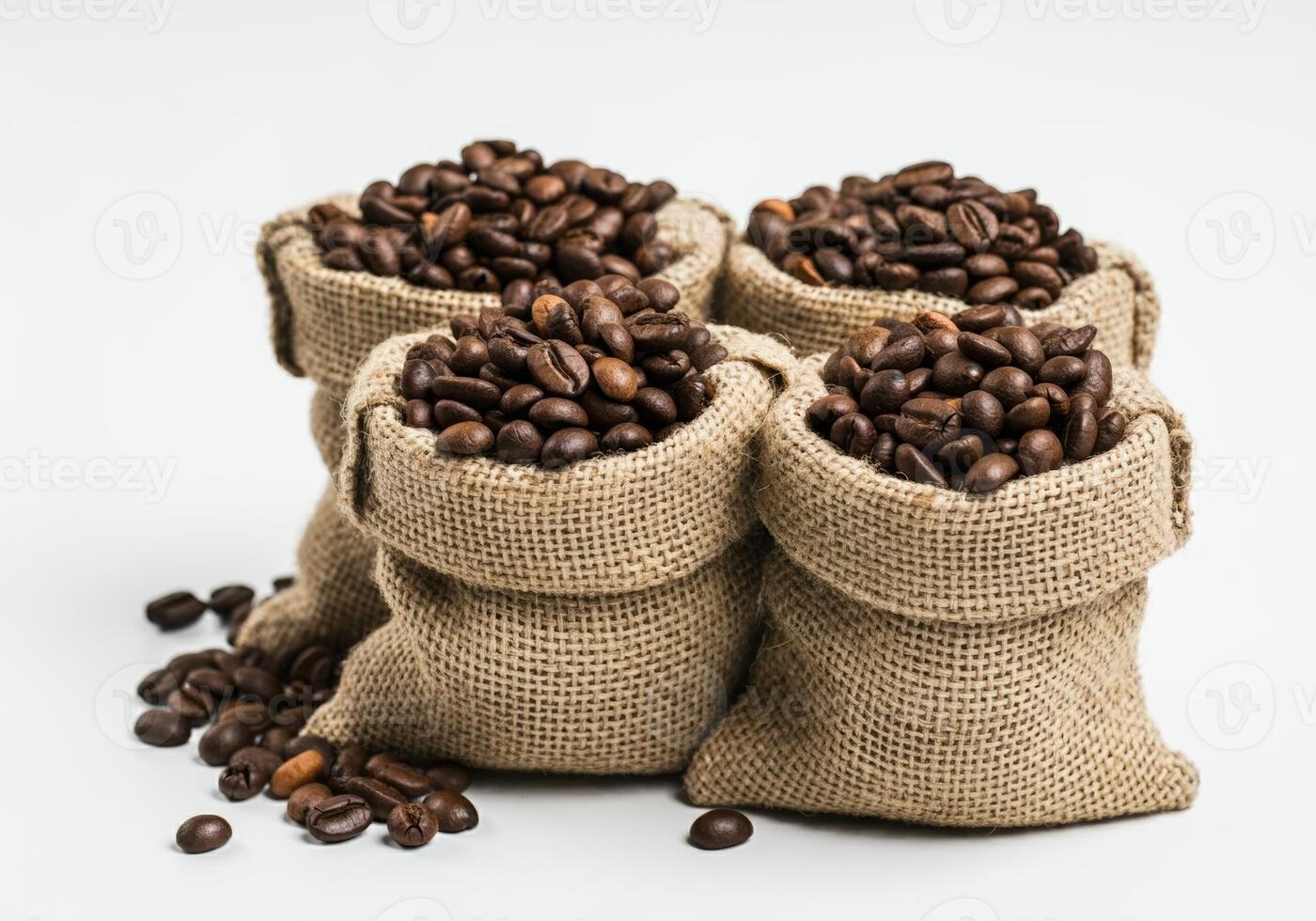 Four Burlap Sacks of Coffee Beans with Scattered Beans photo