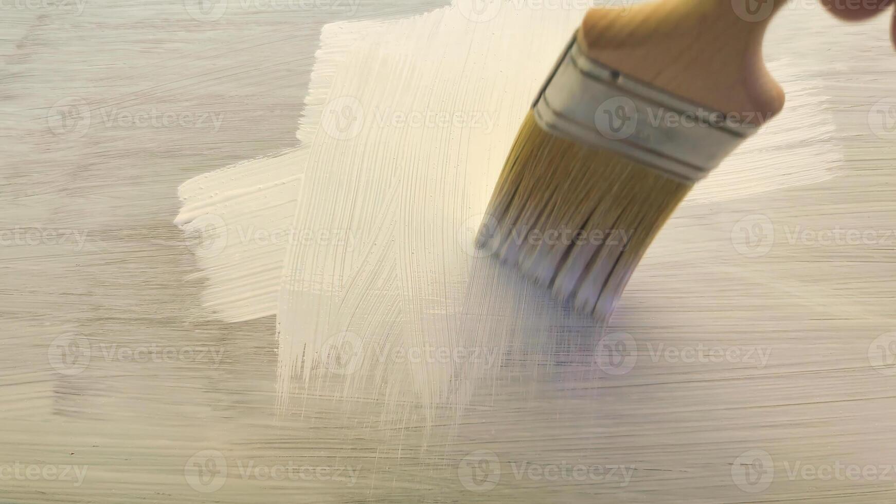 Painting a fresh canvas with gentle brush strokes during a serene afternoon in a sunlit studio photo