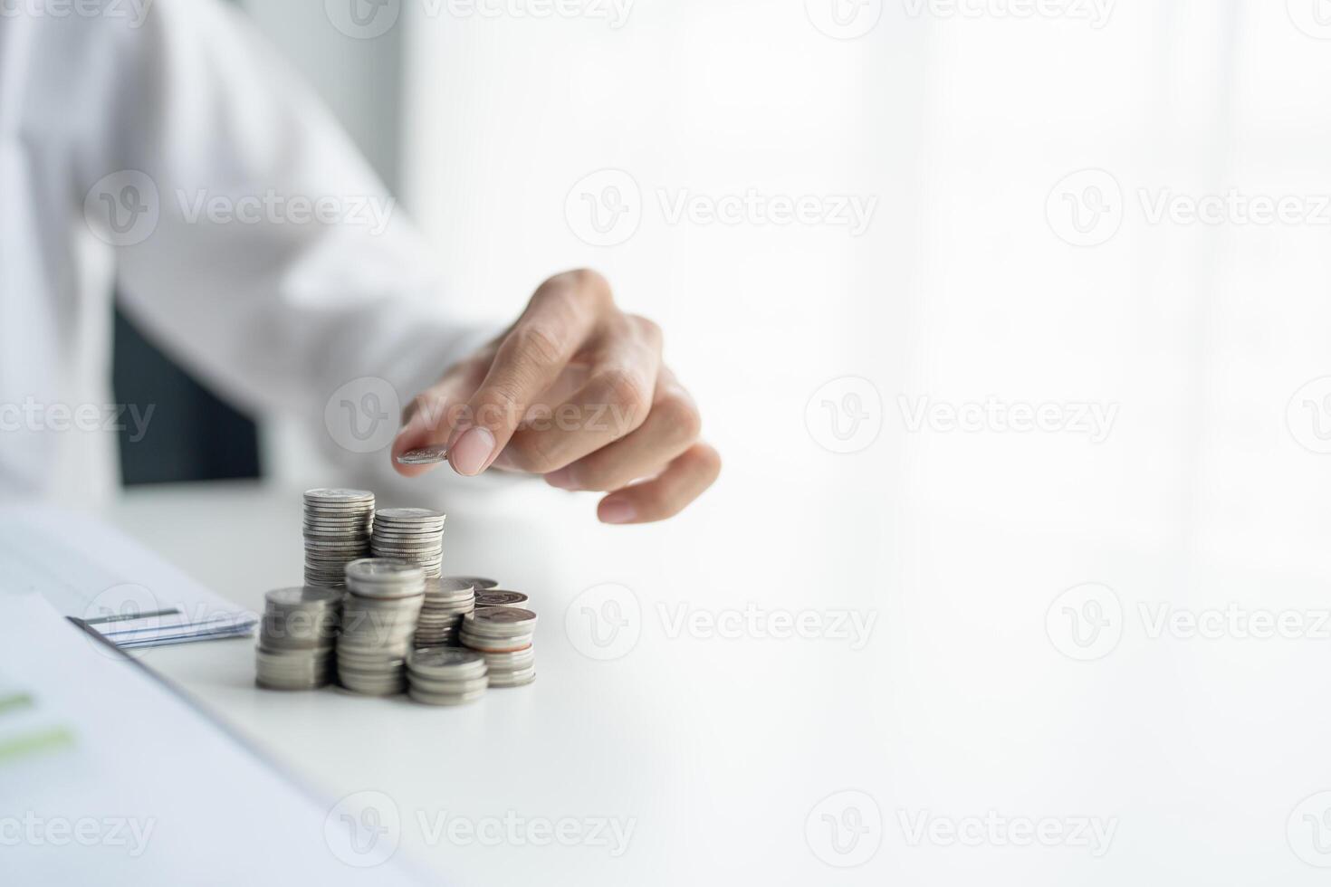 Saving money. Man calculate finances home pay bills taxes savings economy financial at home and saving money stacking coins with calculator. photo
