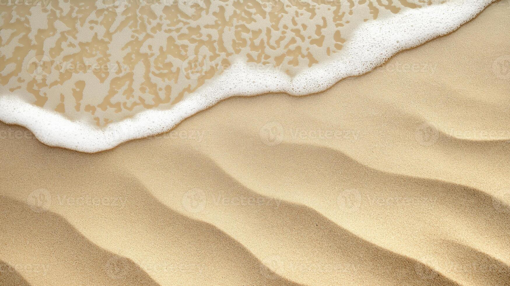 Close-up of sandy beach with wave foam touching rippled sand patterns created by water photo