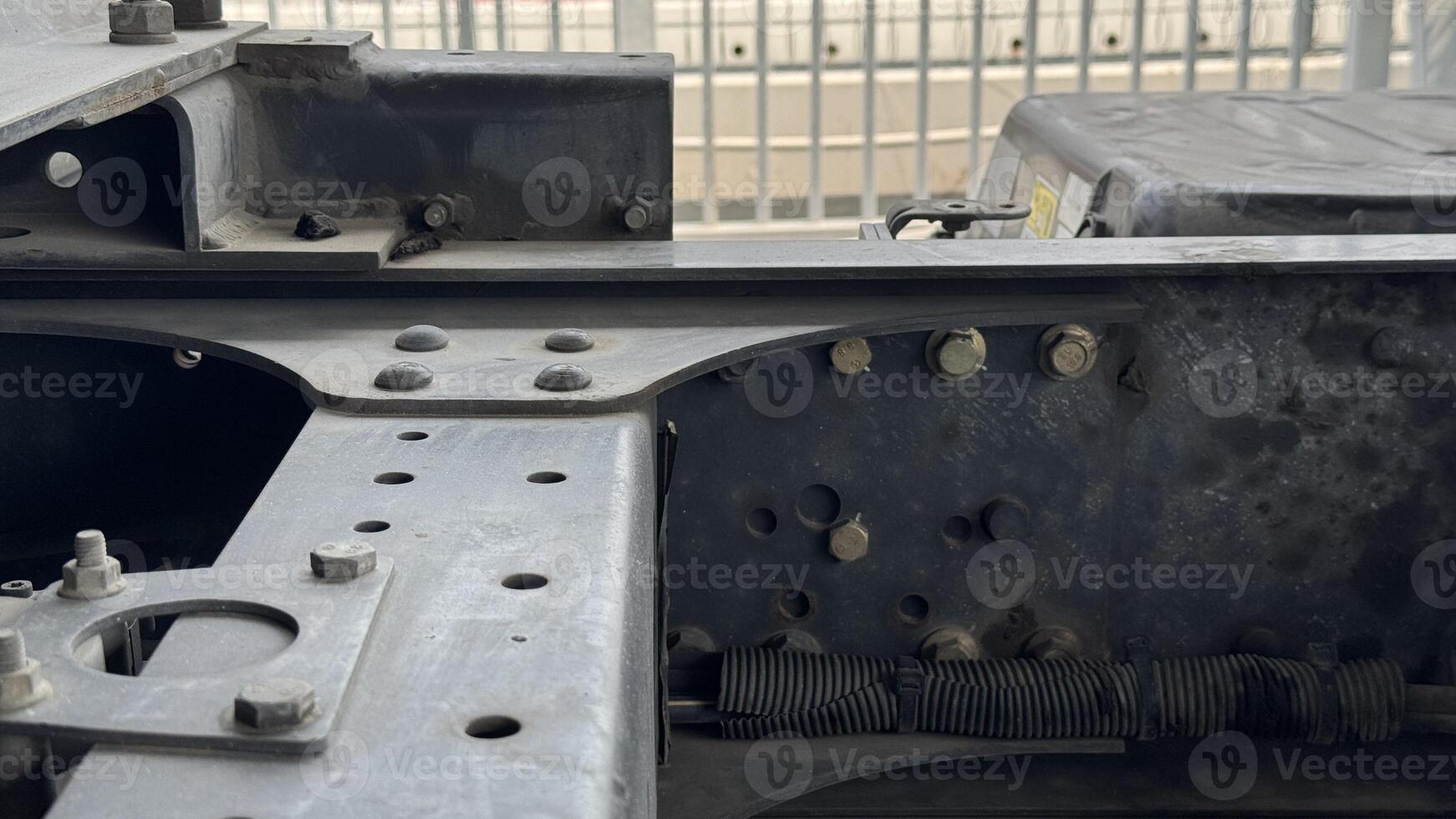 Truck Chassis Frame Details A close-up image showcases the intricate structural details of a heavy-duty truck chassis frame, highlighting the robust engineering and durability of the vehicle. photo