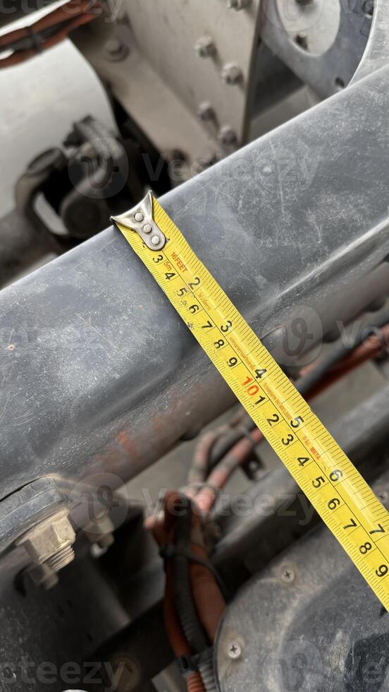 Precise Measurement A detailed close up shows a measuring tape stretched across an industrial component, illustrating precision and attention to detail. photo