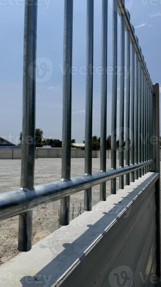 Protective Barrier and Structure A striking image of a modern metallic fence, creating a rigid barrier, highlighting the precision of design, construction, and solid foundation. photo