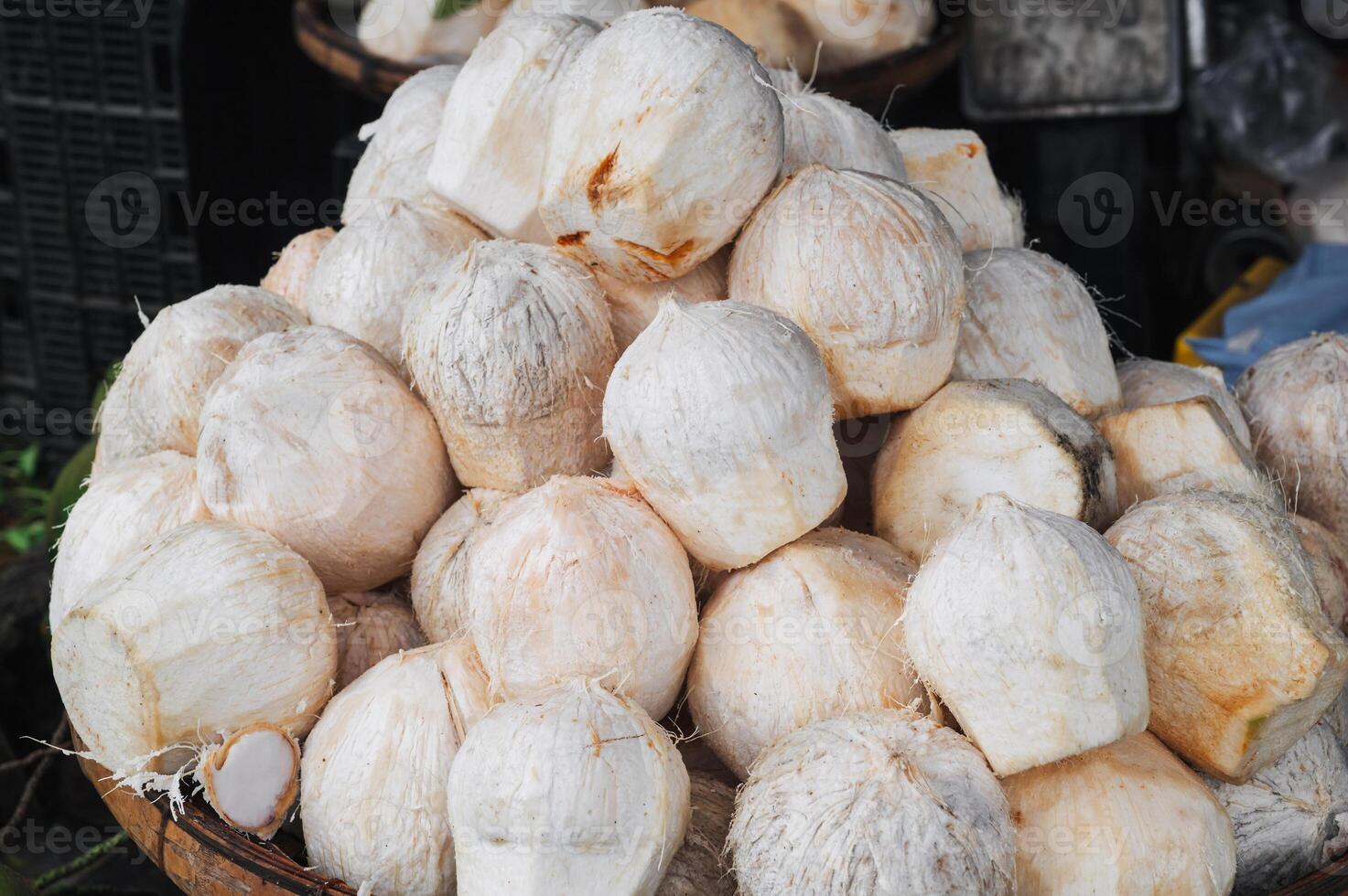 white young drinking coconuts on the counter at Asian market photo