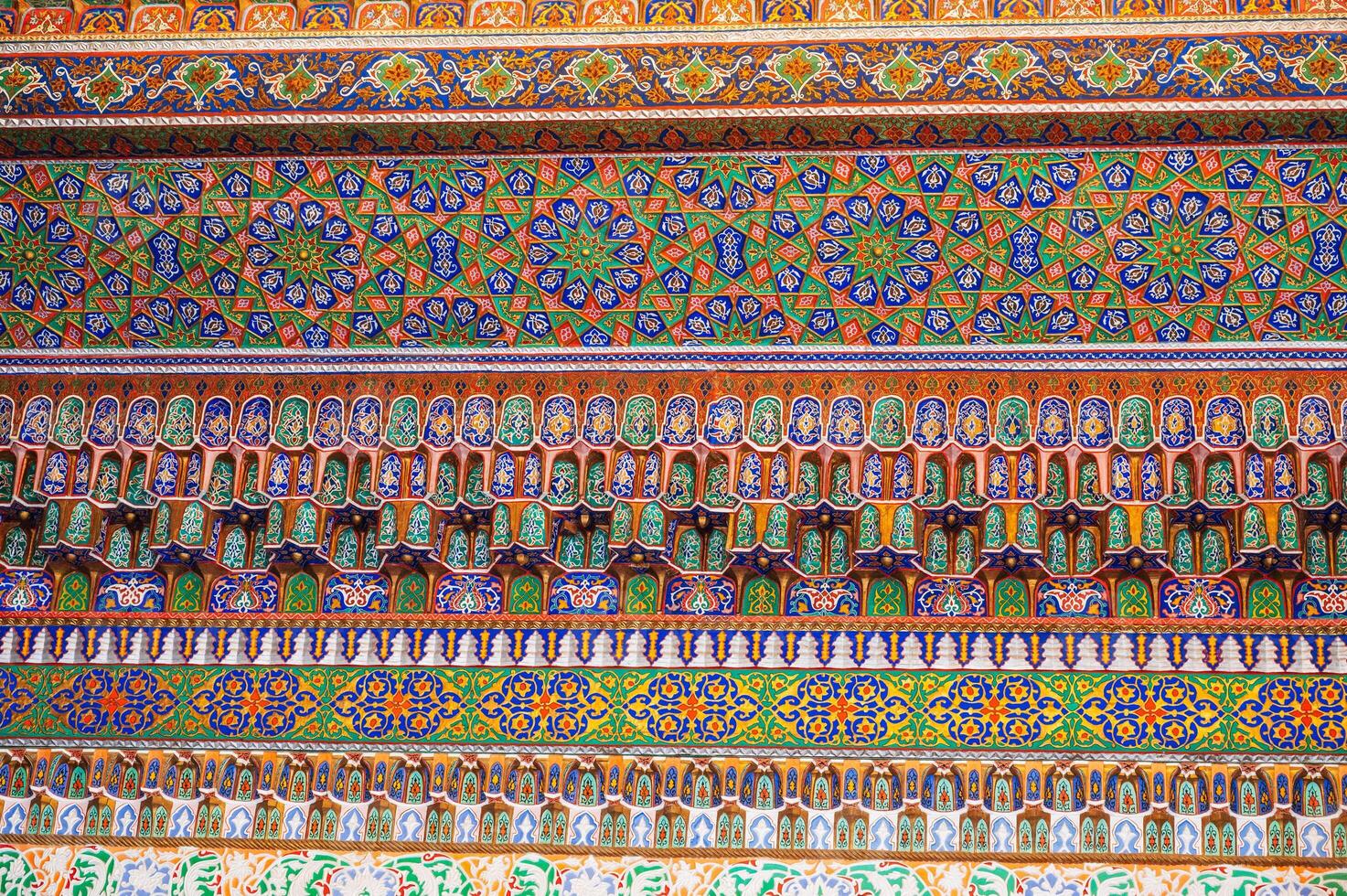painted carved wooden background with traditional Uzbek ornaments and colorful oriental patterns in Uzbekistan photo