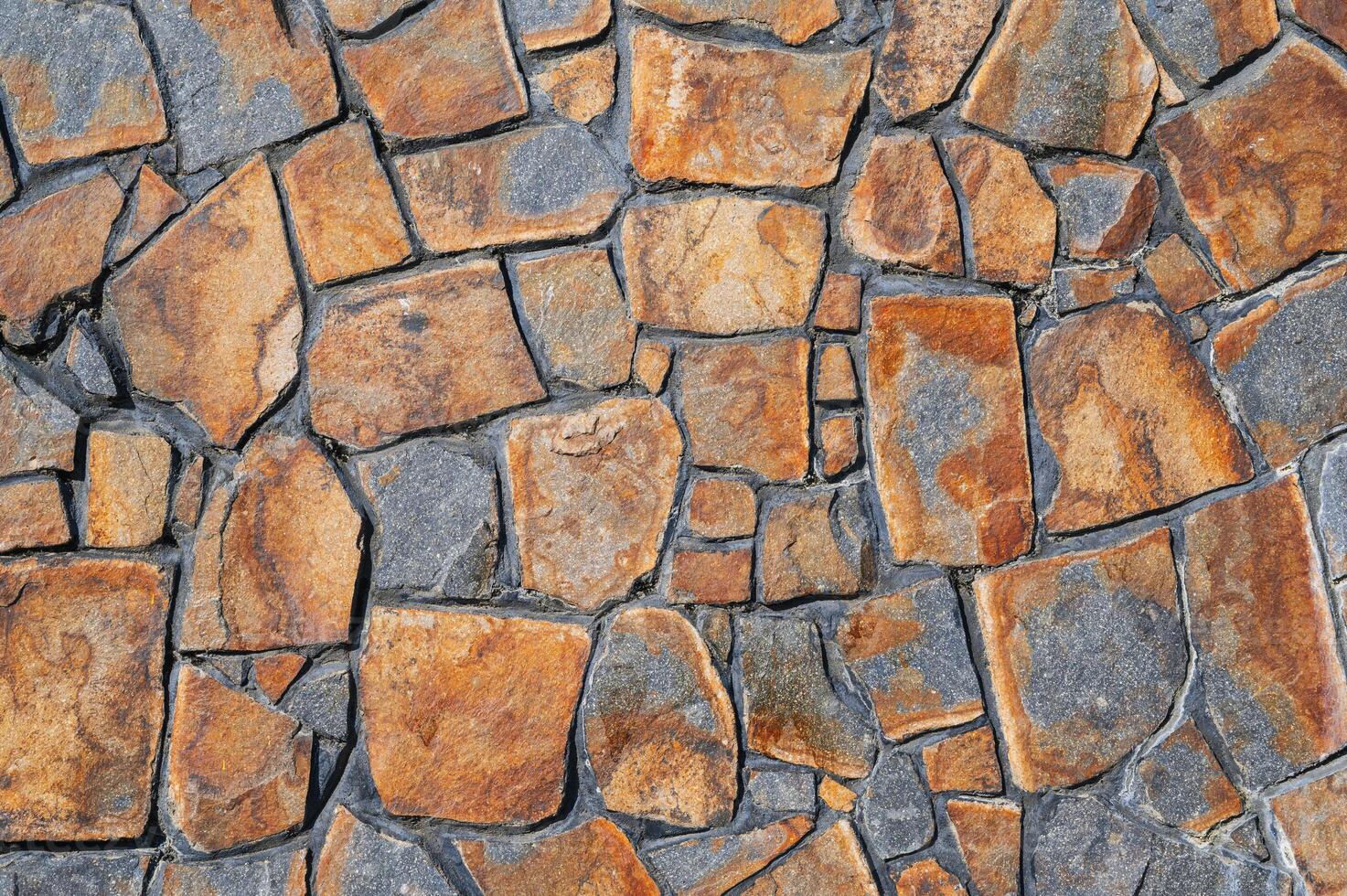 Fragment of a wall from a chipped stone. Wide panoramic stone pattern. photo