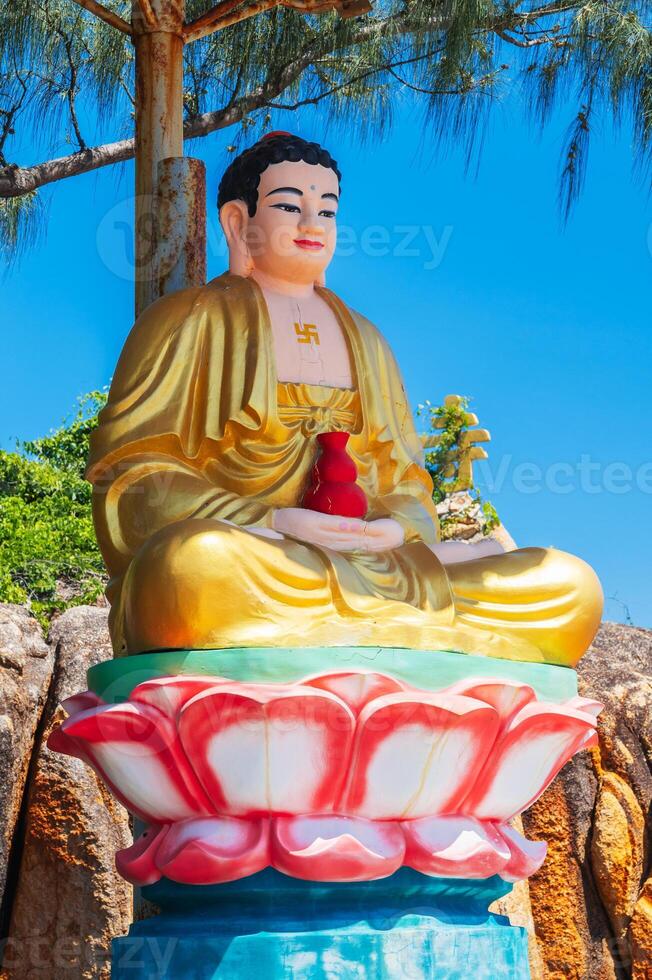 An altar with a sitting Buddha on the territory of a Buddhist temple in Asia. photo