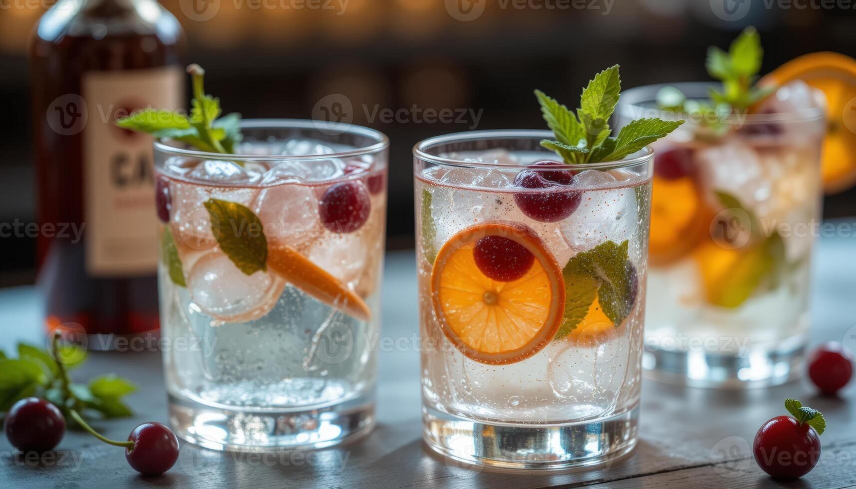 Trio of elegant, transparent glasses filled with refreshing cocktails garnished with fruit and mint on a dark table, perfect for social gatherings, parties, or beverage marketing. photo
