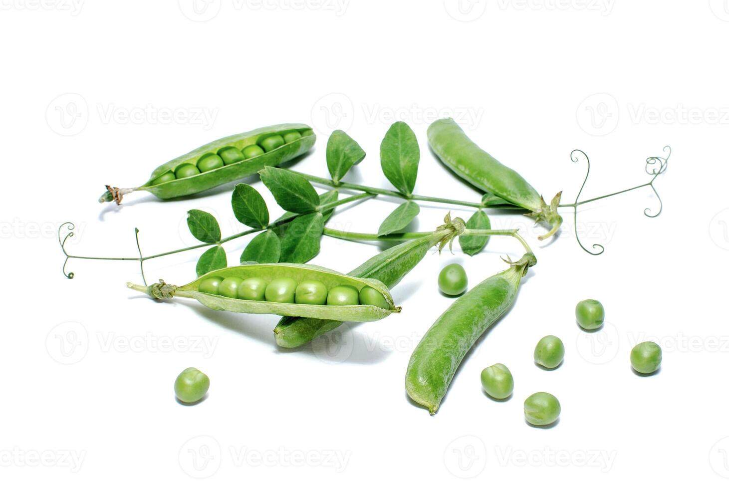 Pods of green peas with leaves isolated on white photo