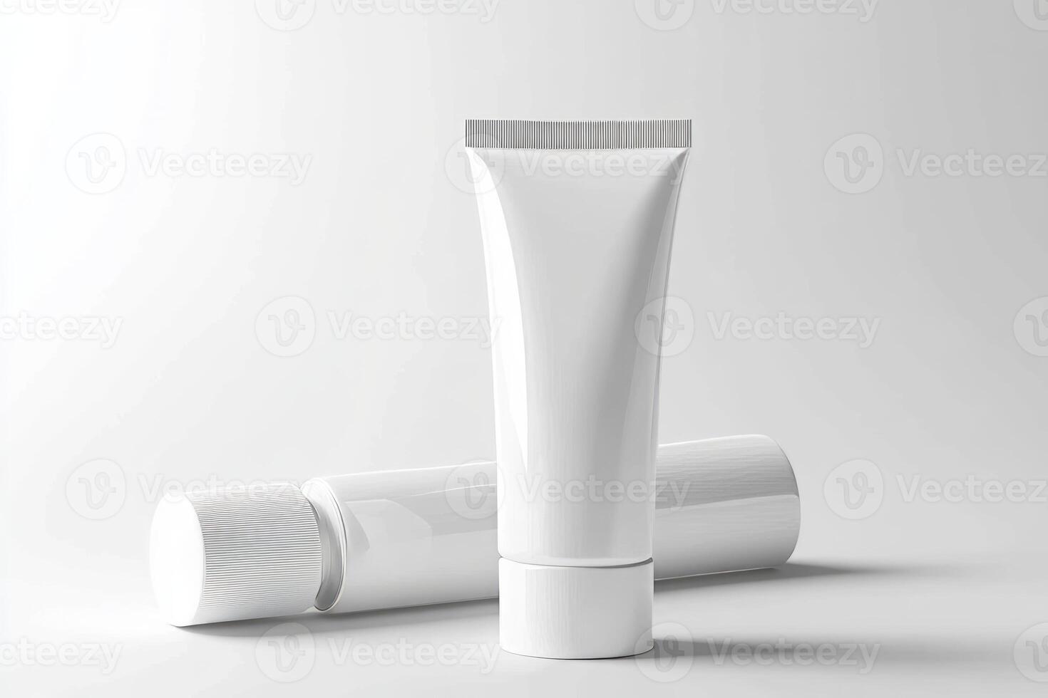 A tube of cream and a tube of toothpaste on a white background photo