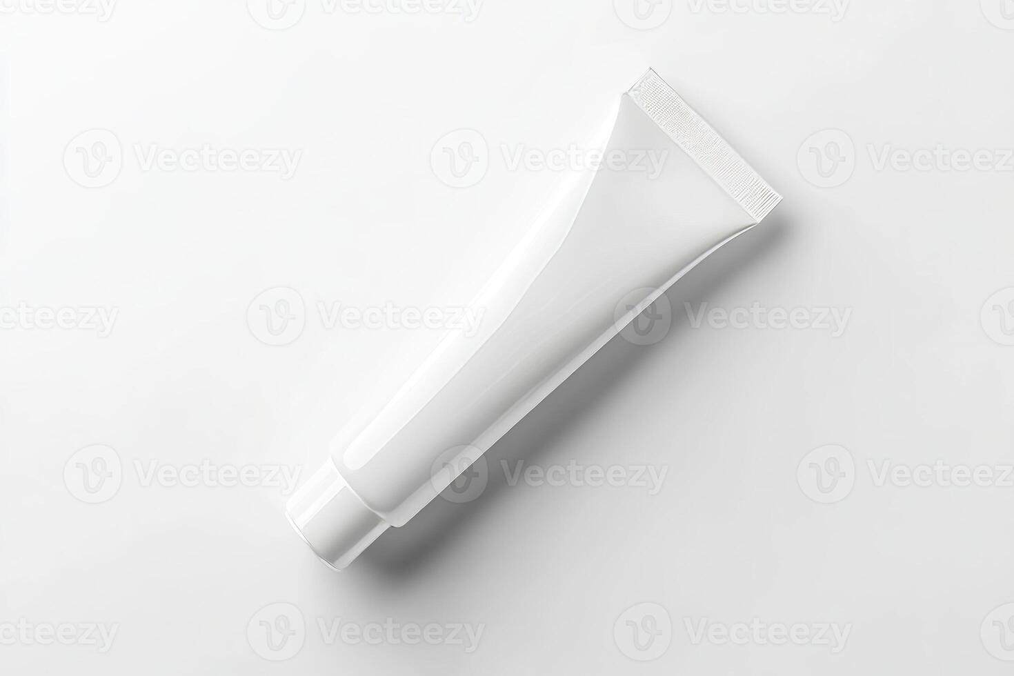 A tube of toothpaste on a white surface photo