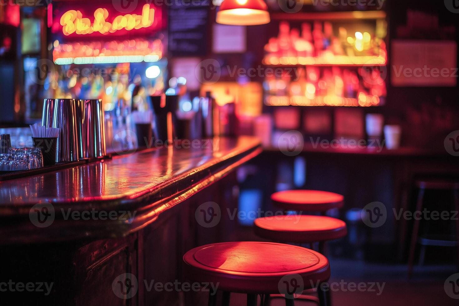 Neon signs illuminate empty bar stools at a vibrant cocktail lounge during evening hours photo