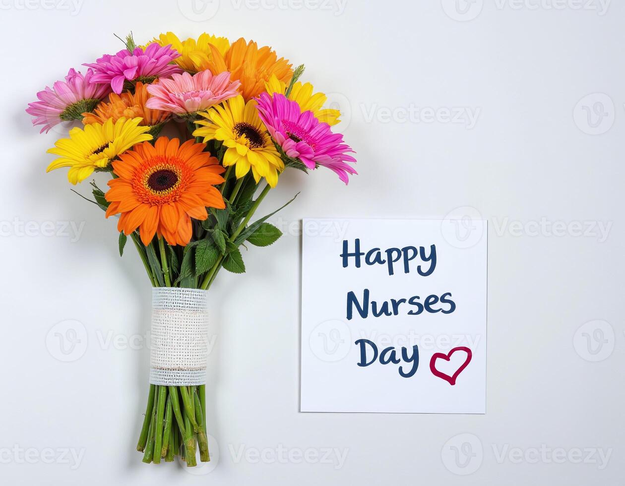 Colorful bouquet of gerbera daisies pink, yellow, orange wrapped with white burlap, next to a card that reads Happy Nurses Day with a red heart. Isolated, Celebrating Nurses Day photo