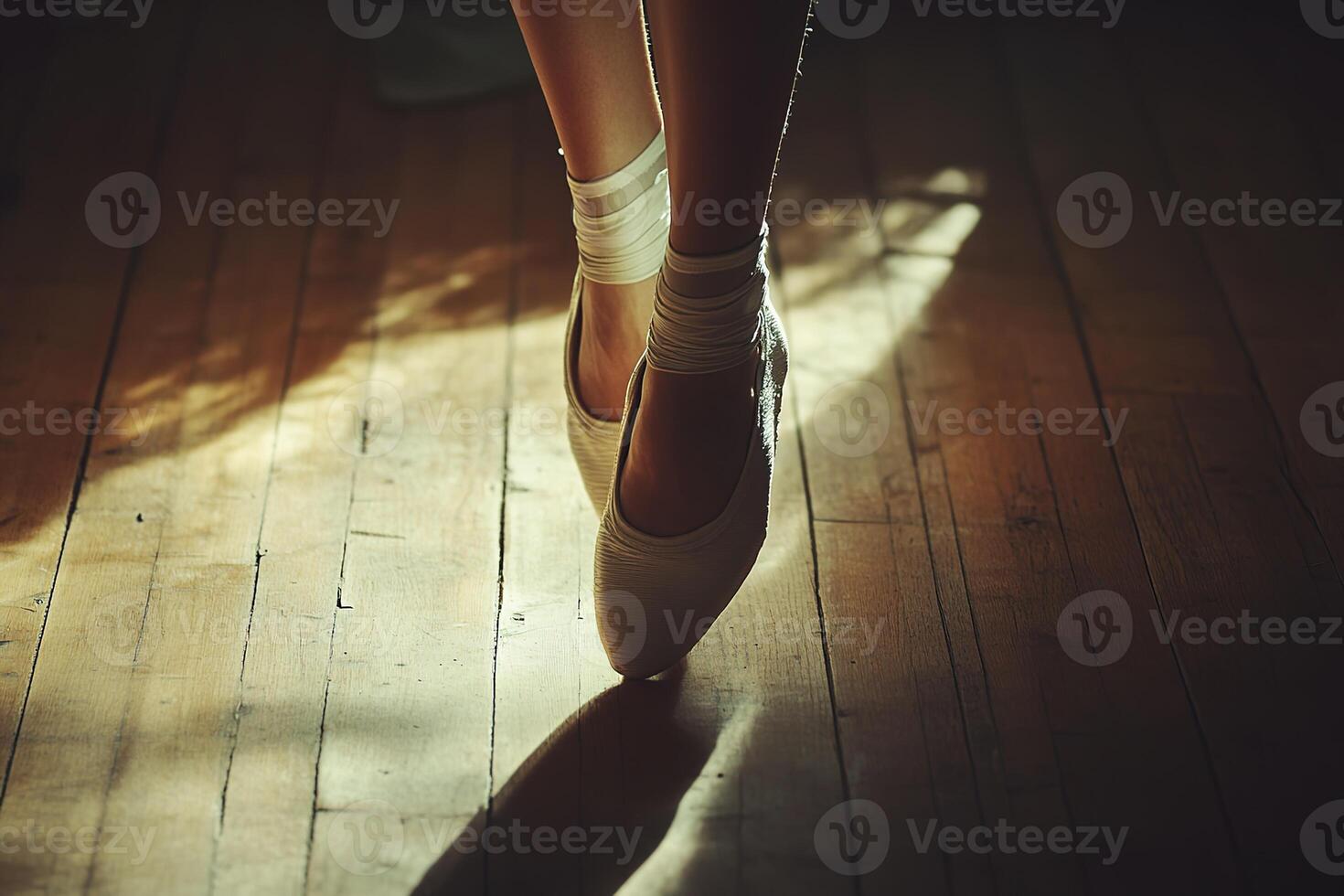 close-up ballet dancer's feet in pointe shoes, soft ribbons elegantly tied, on a polished wooden floor, natural side lighting creating subtle shadows photo