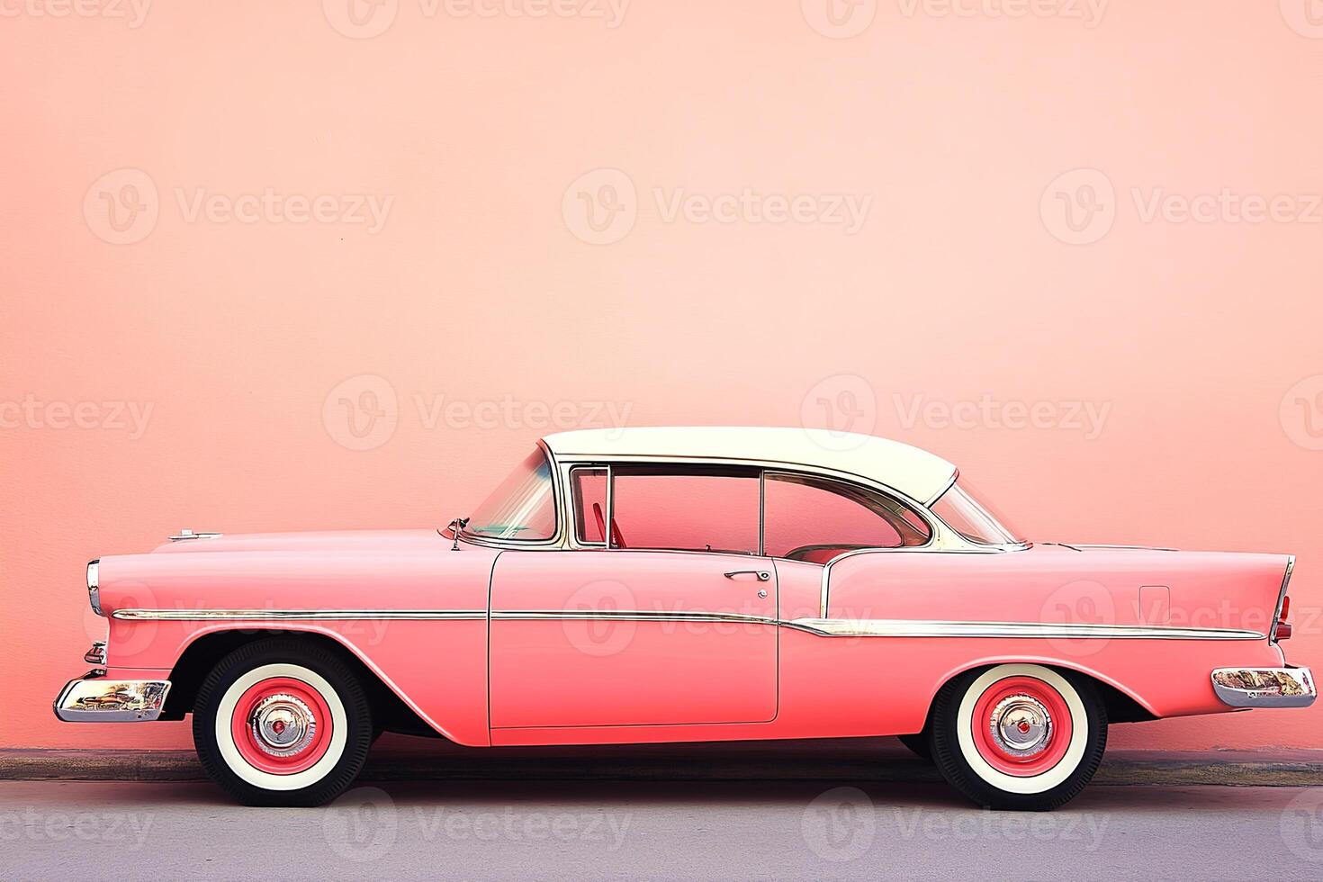 close-up image side view of stylish luxury retro vintage car parked against pastel pink wall photo