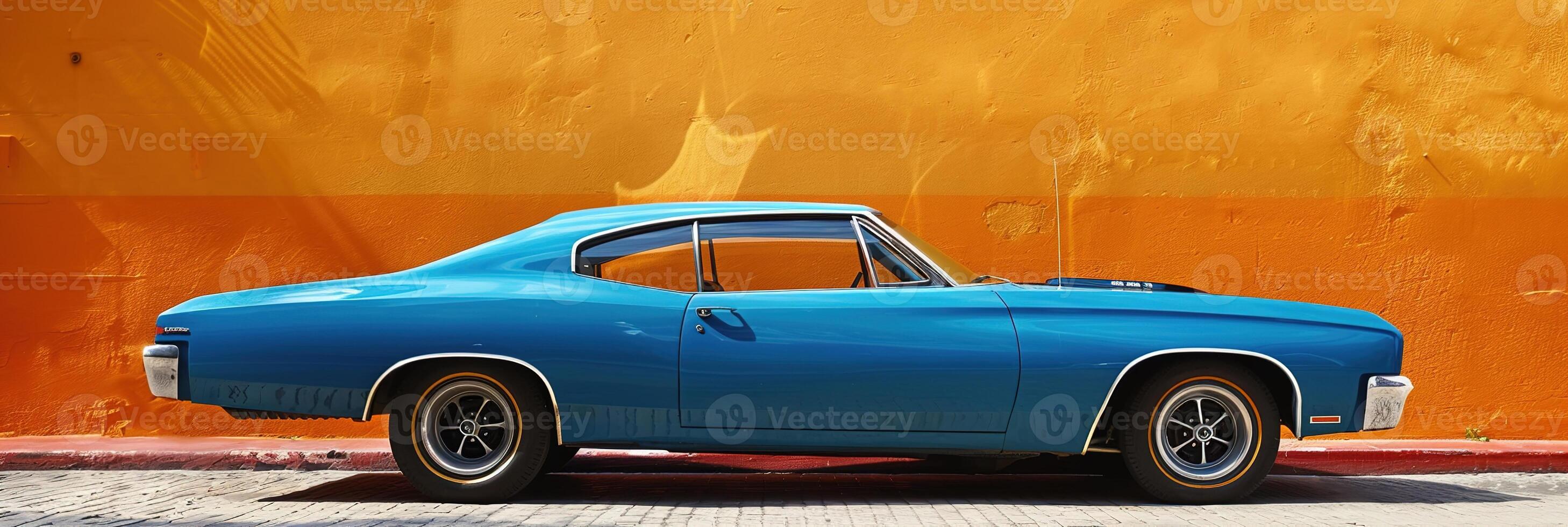 stylish blue classic retro vintage car stands against bright orange wall on sunny day photo