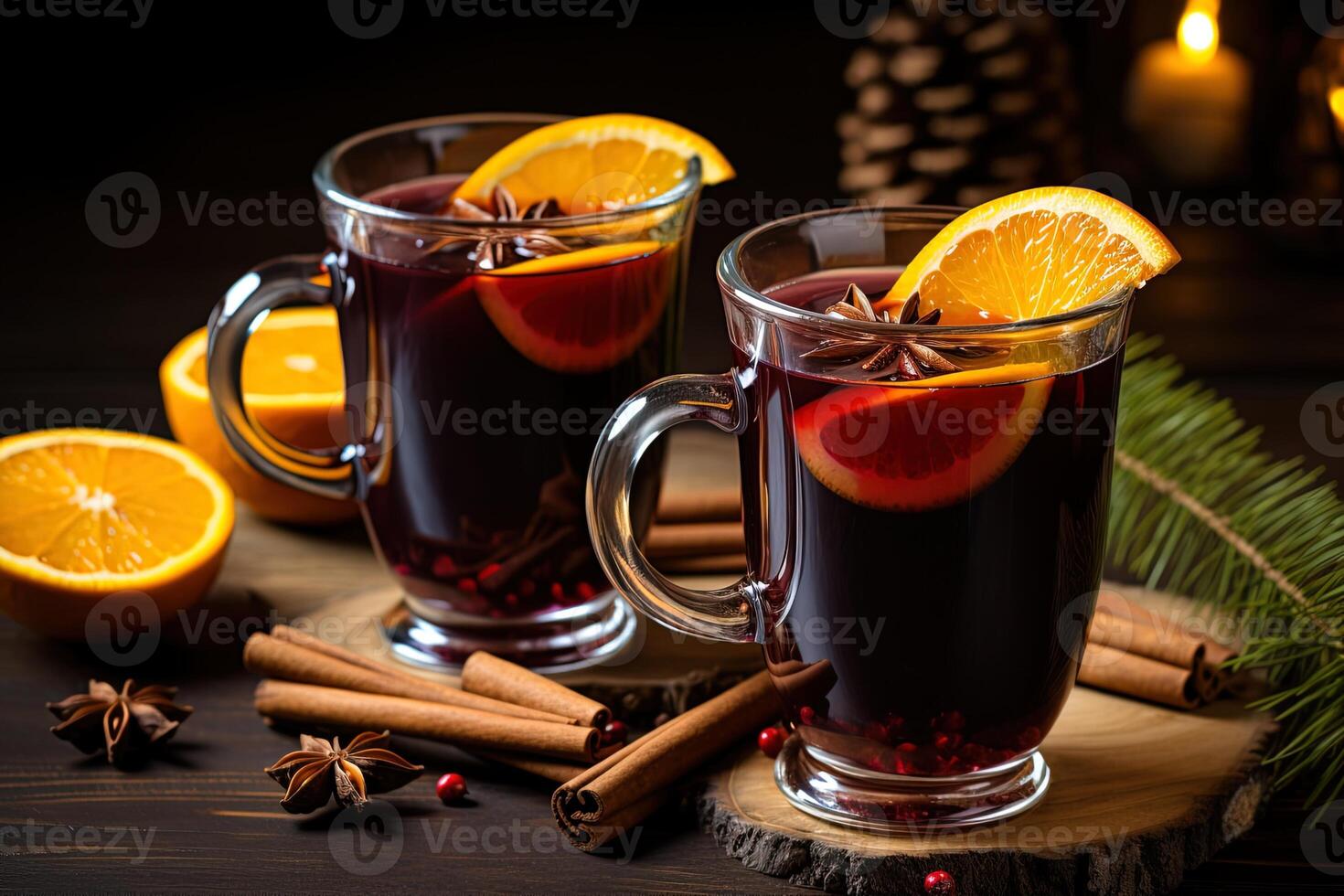 still life with two glasses of aromatic mulled wine on wooden stands, decorated with oranges, cinnamon sticks, anise stars and a fir branch photo