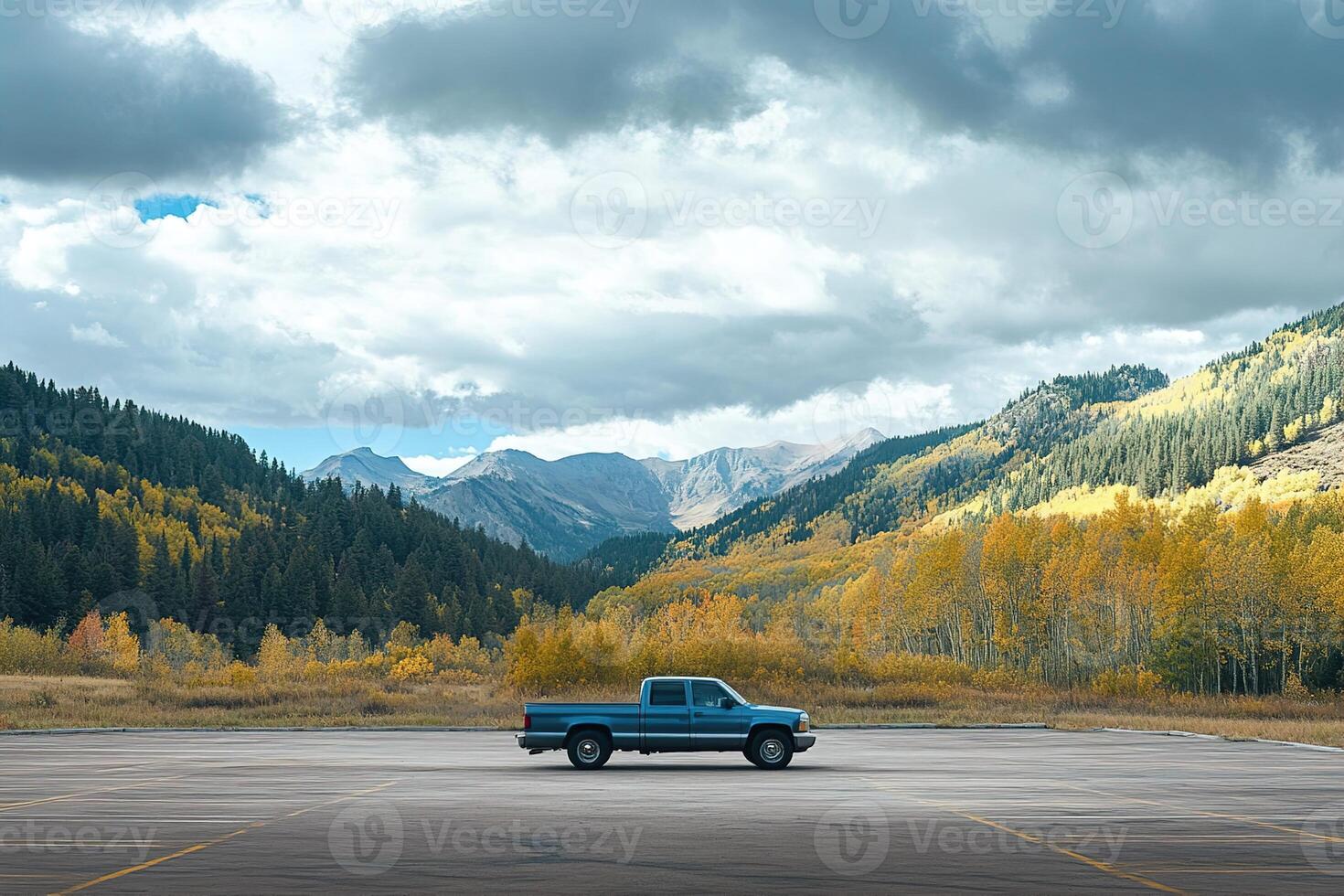lonely pickup truck parked in a parking lot in the autumn mountains in cloudy day photo