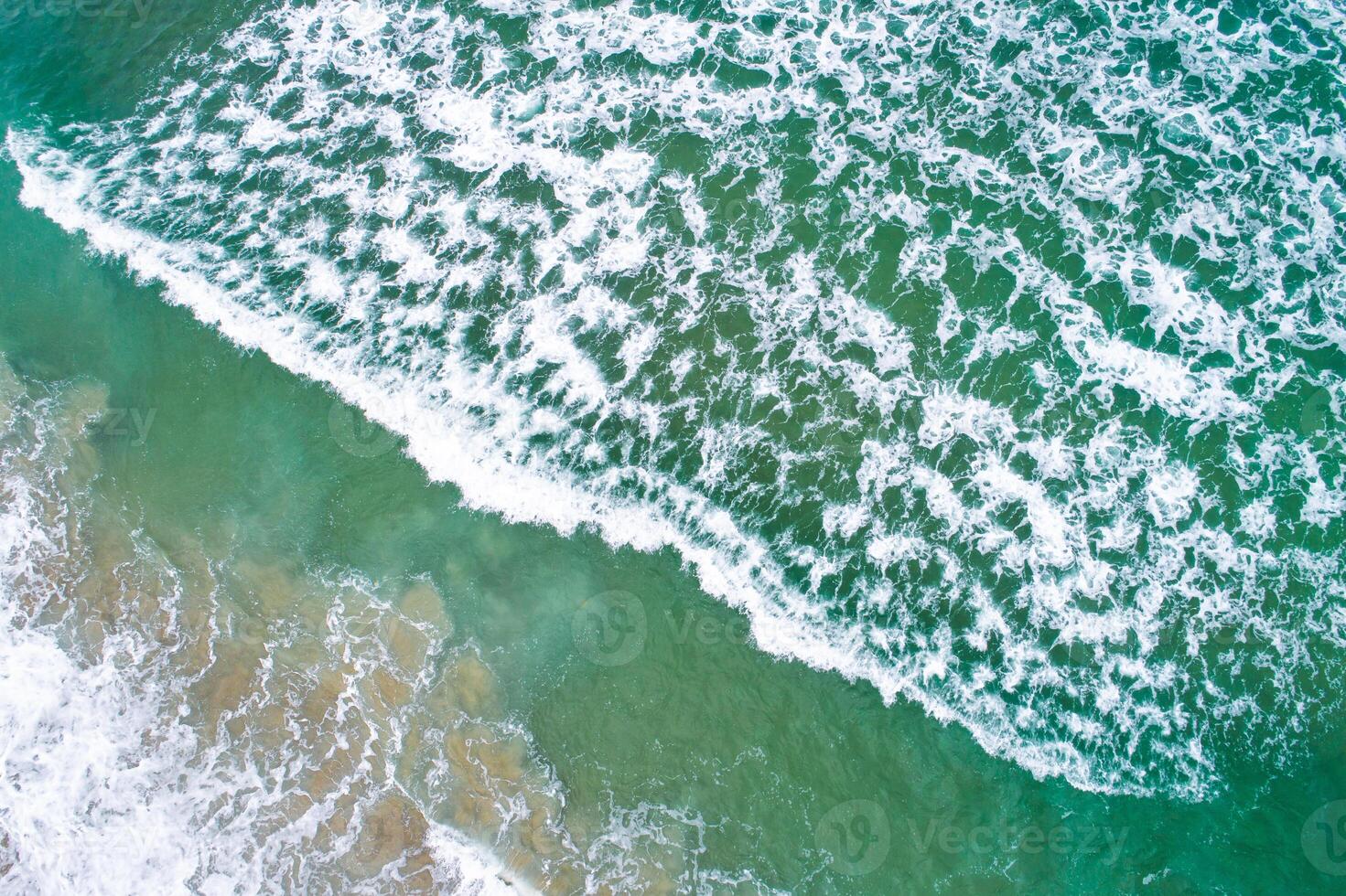 aerial perspective of a dynamic breaking wave, aerial drone photography photo