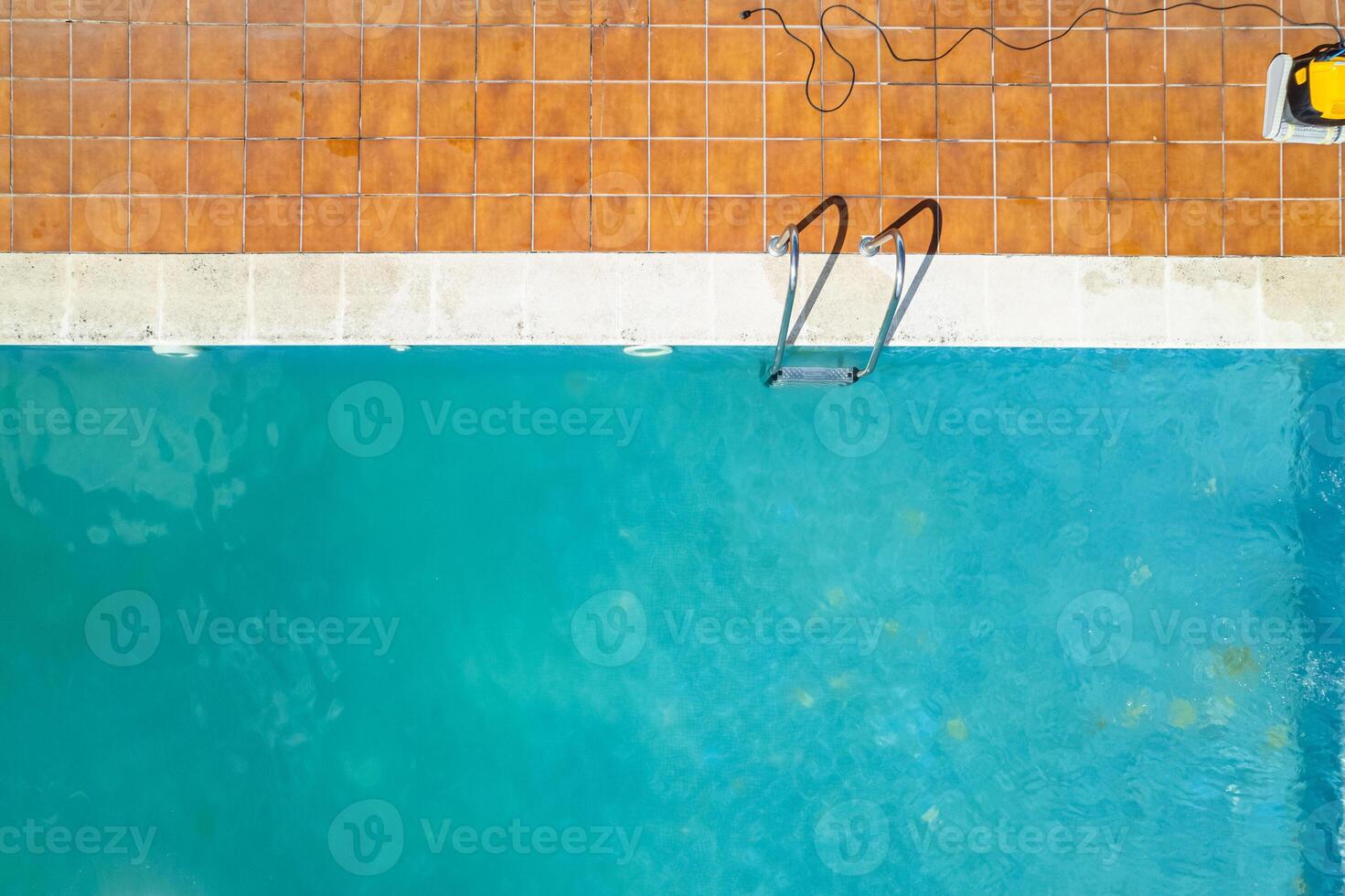 aerial landscape of a private swimming pool with blue water, zenithal drone view photo