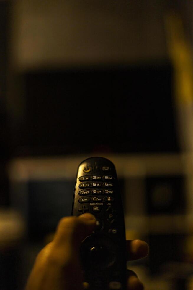 Use the TV remote In Dark Room photo