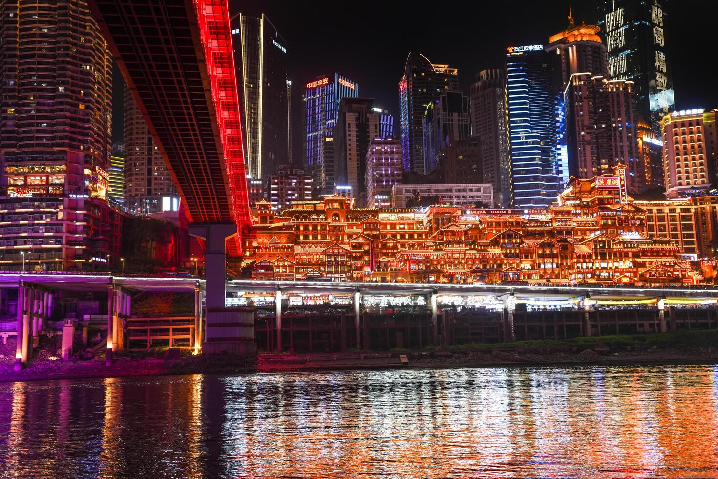 Chongqing, China -APR 02, 2025- Night view Cityscape of the famous downtown shopping complex Hongyadong with illuminated bridge and highrise building in Chongqing, China photo