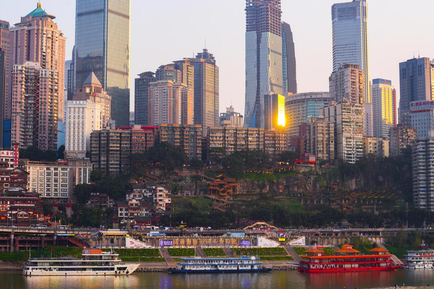 Chongqing, China-APR 02, 2025-Cityscape of the famous downtown shopping complex Hongyadong with illuminated bridge and highrise building in Chongqing, China photo