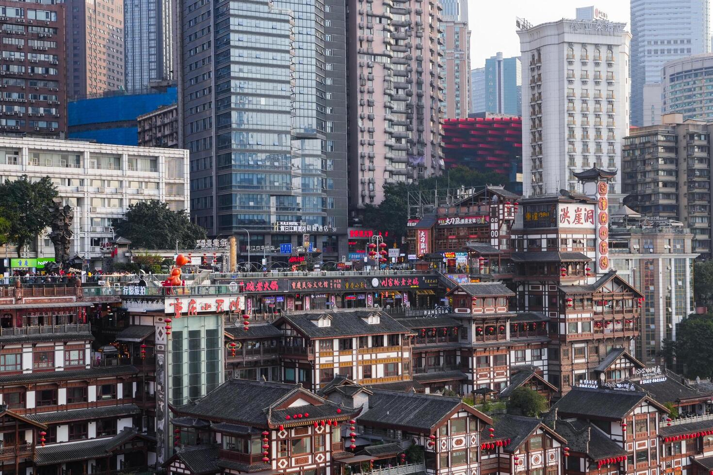 Chongqing, China - APR 02, 2025- Cityscape of the famous downtown shopping complex Hongyadong with illuminated bridge and highrise building in Chongqing, photo